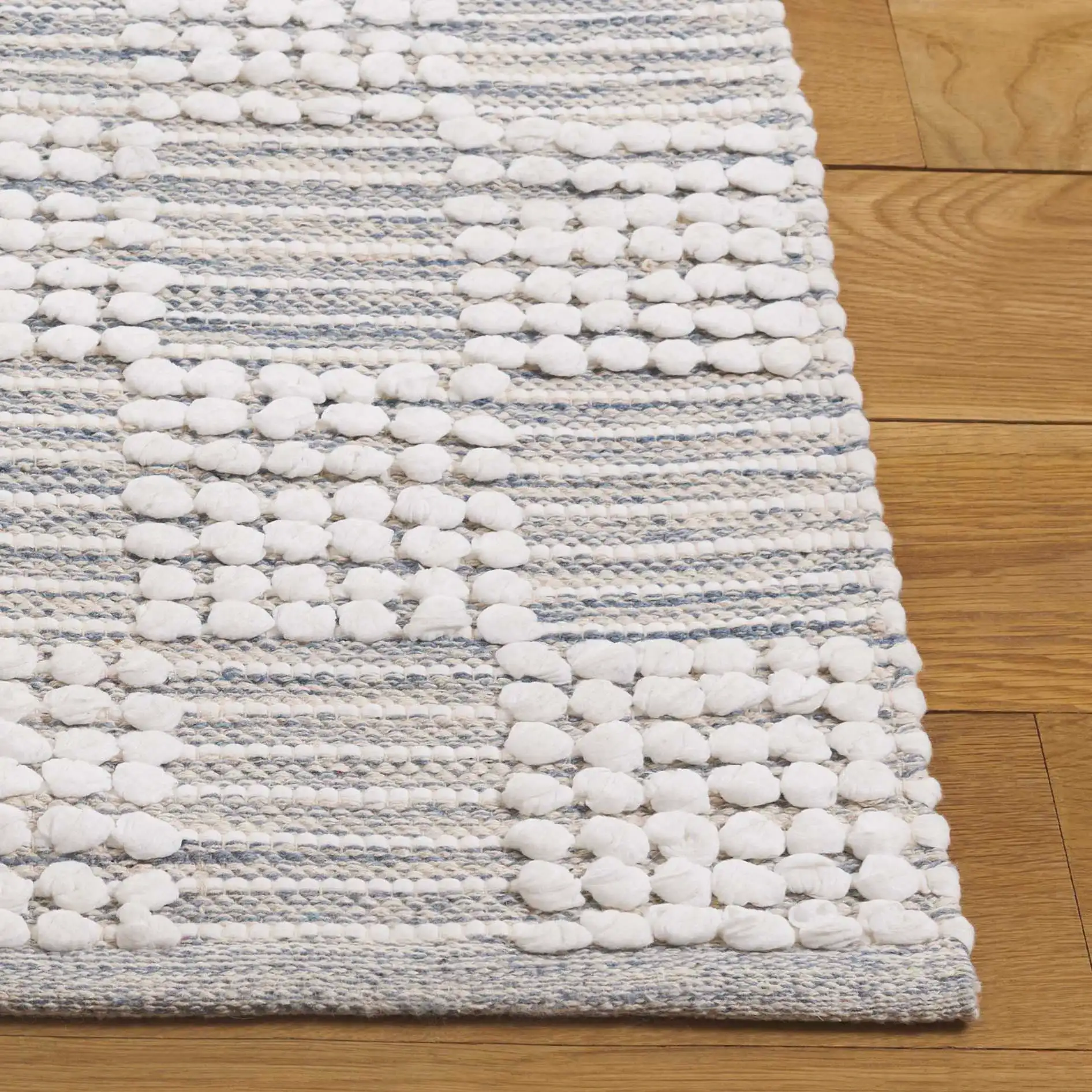 Montauk Checkered Hand-Loomed Cotton Rug in Silver / Ivory in a styled room