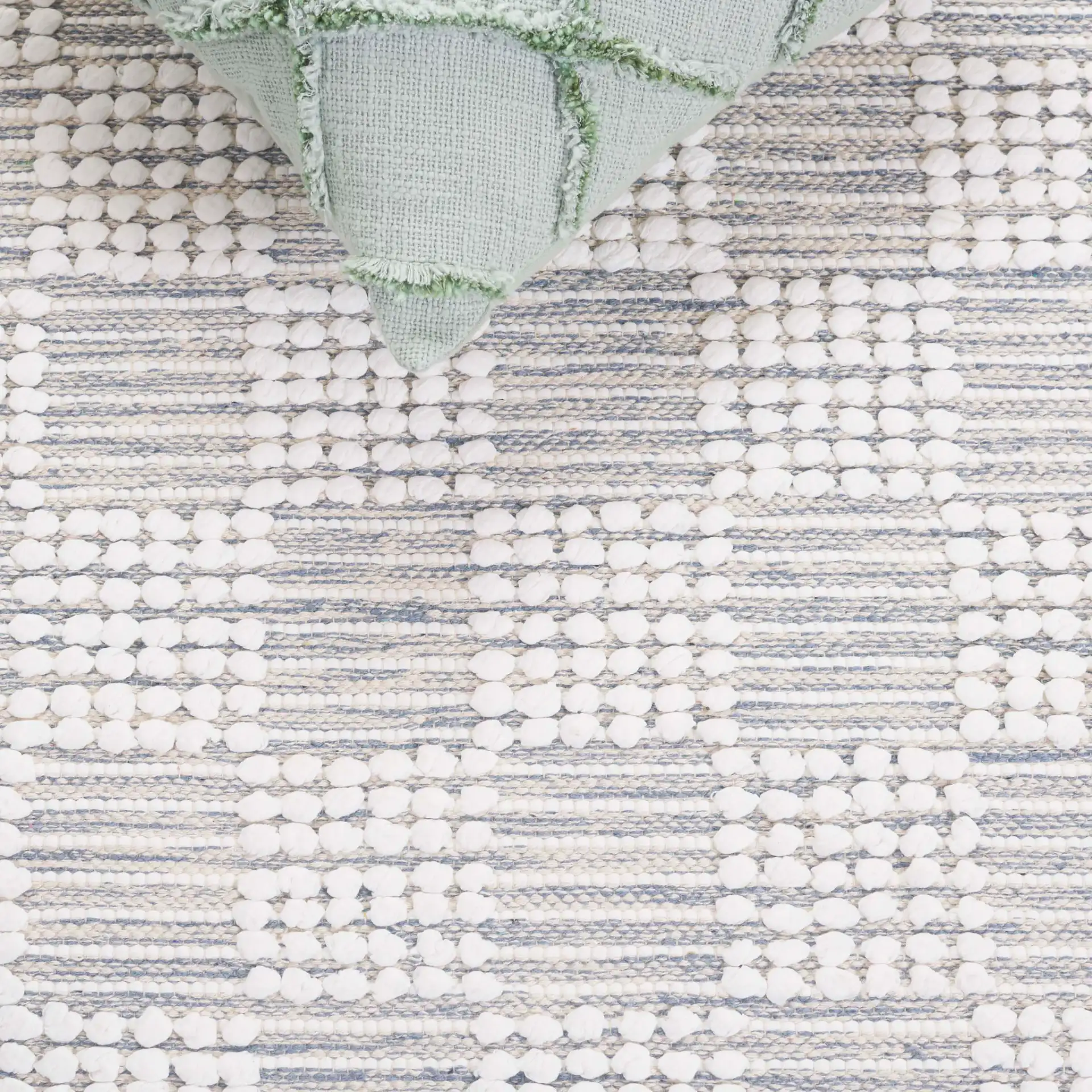 Montauk Checkered Hand-Loomed Cotton Rug in Silver / Ivory in a styled room