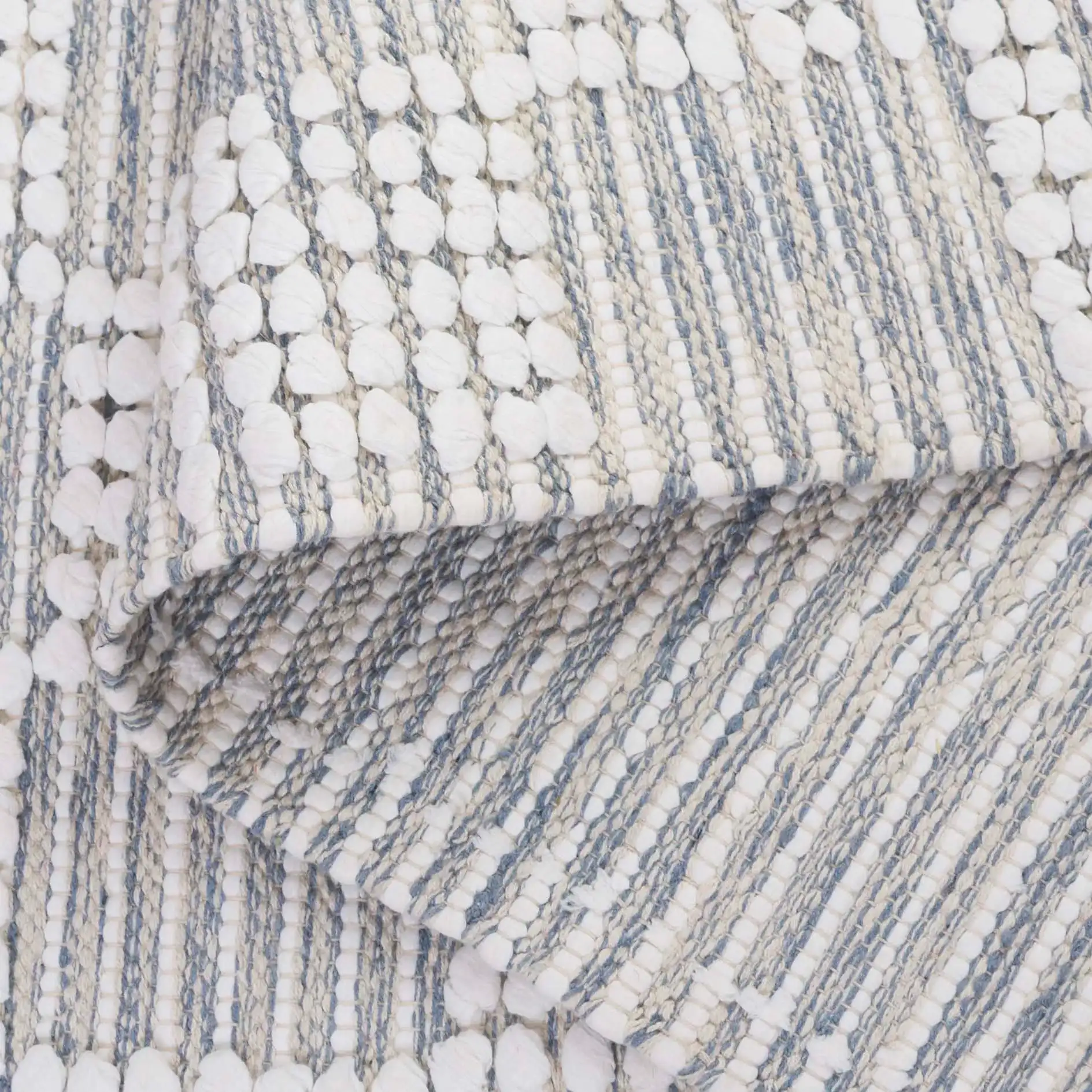 Montauk Checkered Hand-Loomed Cotton Rug in Silver / Ivory in a styled room