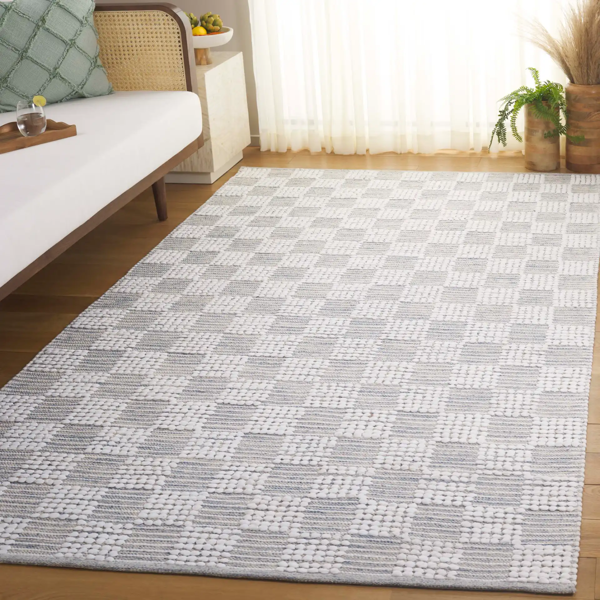Montauk Checkered Hand-Loomed Cotton Rug in Silver / Ivory in a styled room