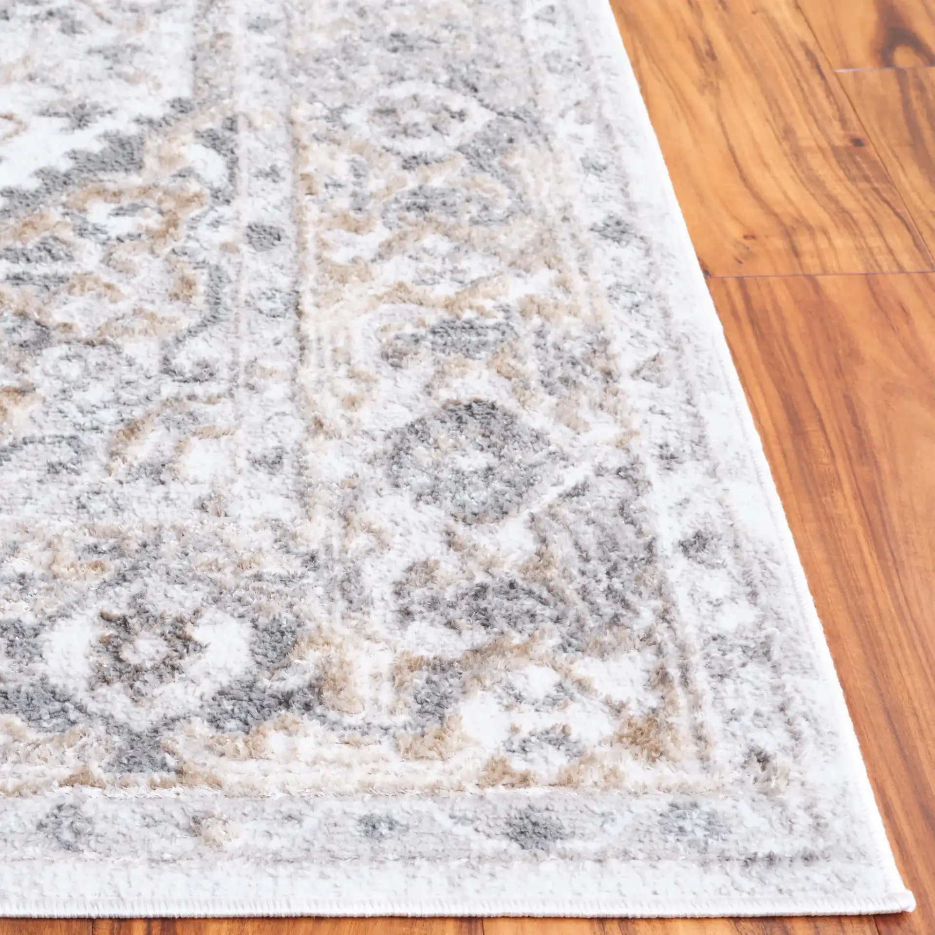 Maya Distressed Medallion Rug in Ivory / Gray Beige in a styled room