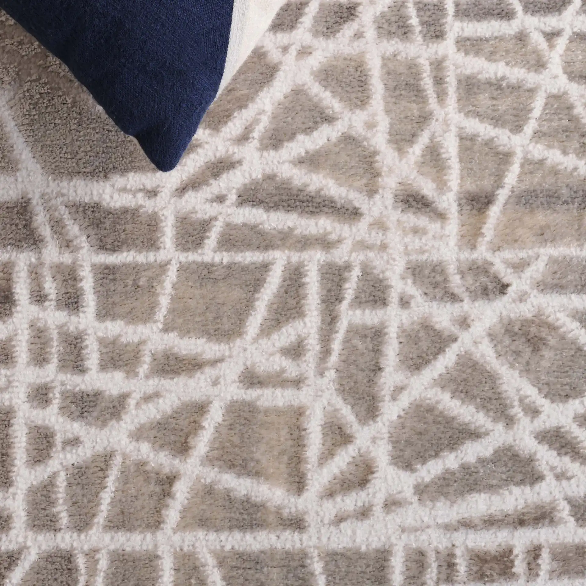 Maya Abstract Grid Rug in Taupe / Gray in a styled room