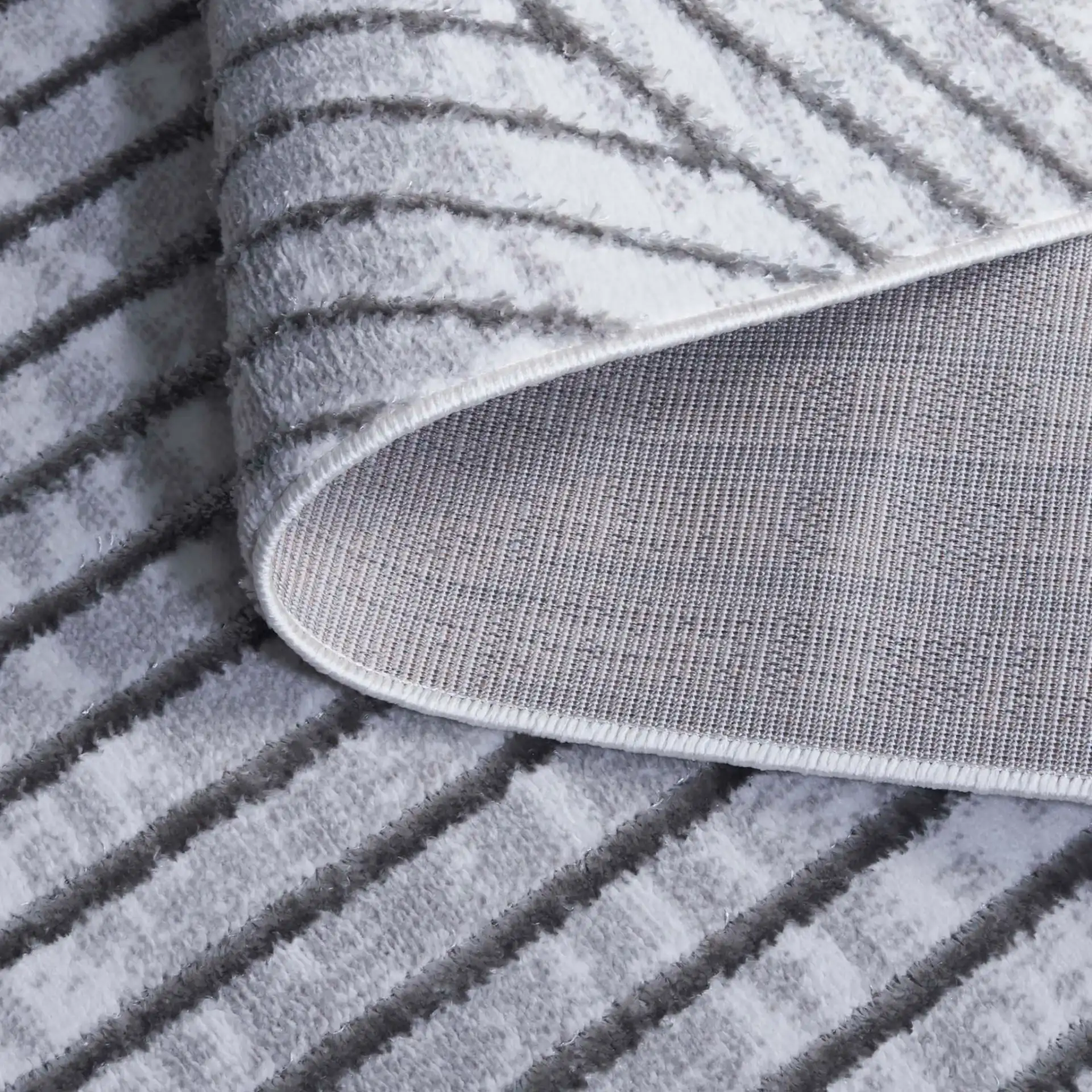 Maya Angled Stripe Rug in Ivory / Gray in a styled room