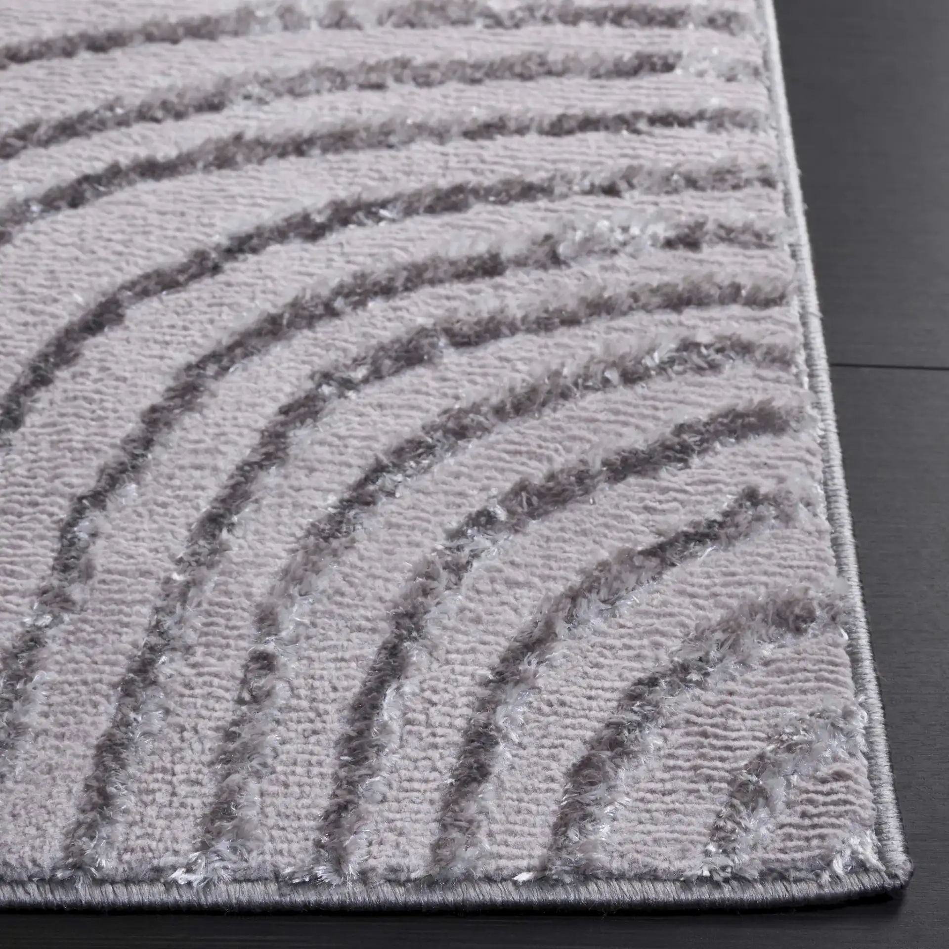Maya Curved Stripe Rug in Ivory / Gray in a styled room