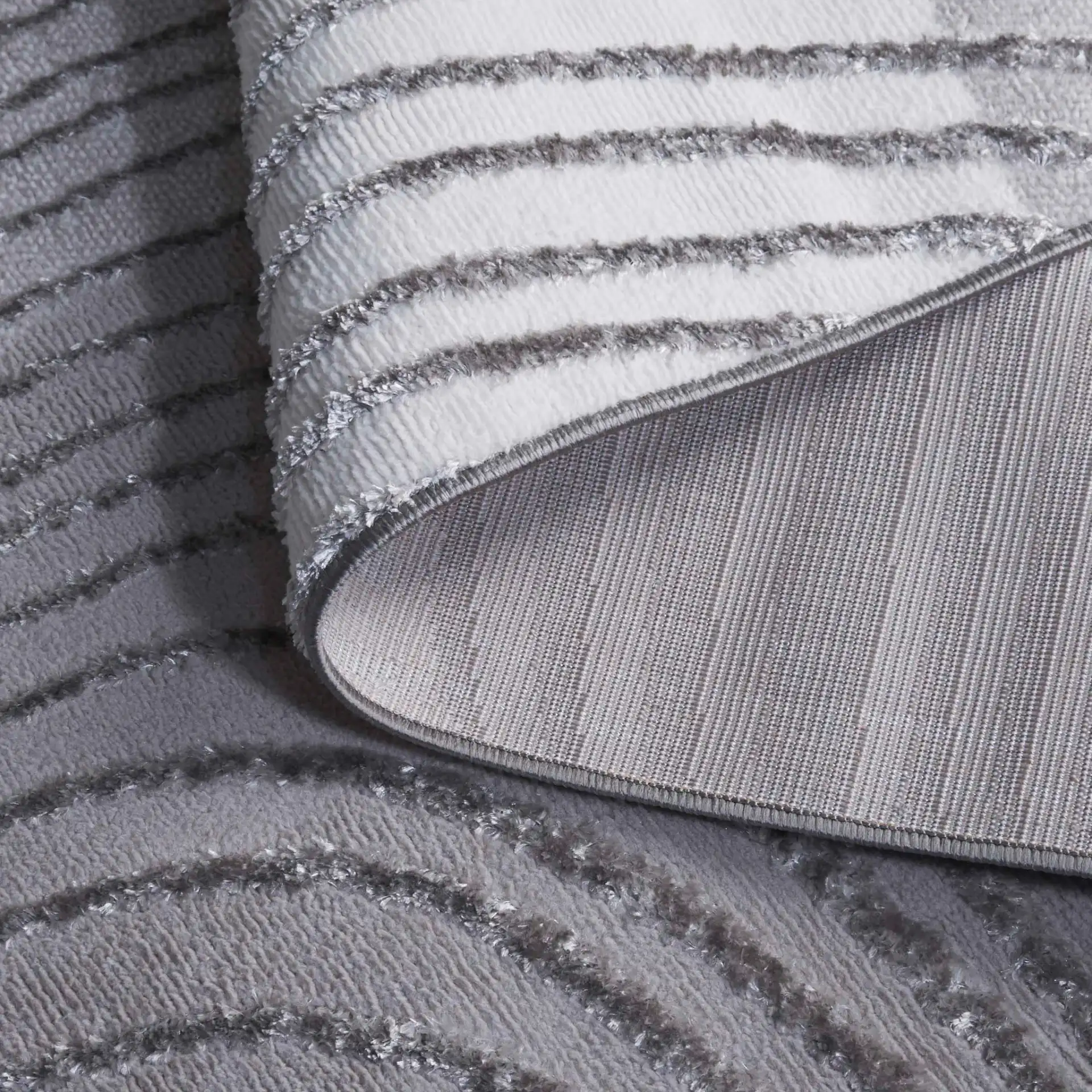 Maya Curved Stripe Rug in Ivory / Gray in a styled room