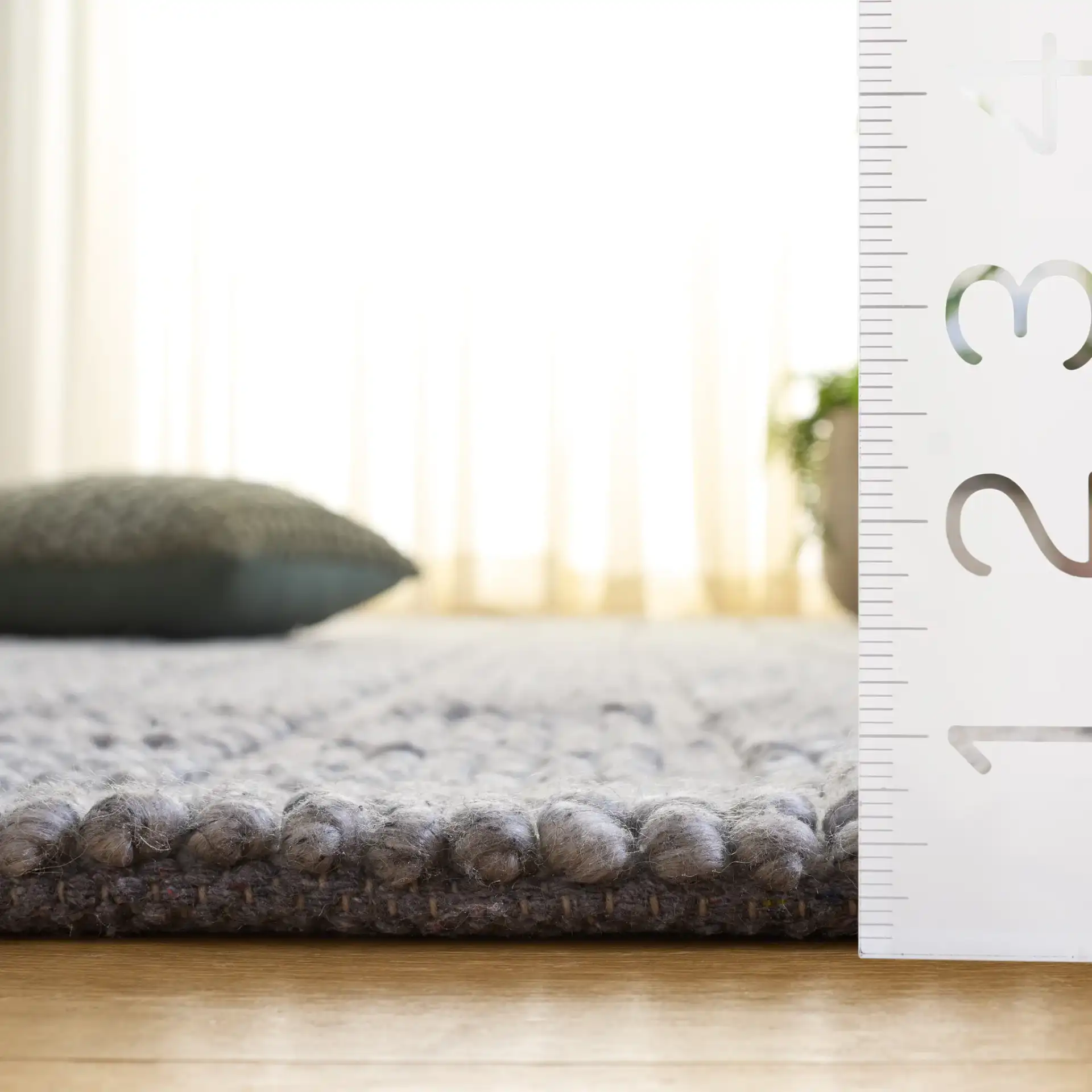 Natura Textured Grid Hand-Woven Rug in Gray in a styled room