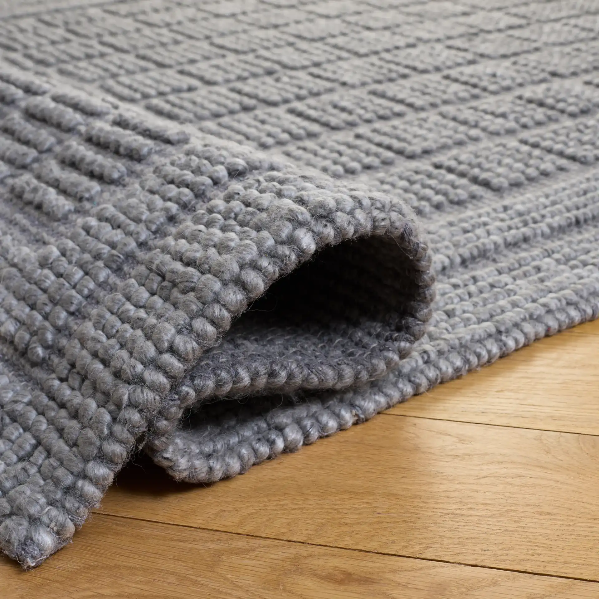 Natura Textured Grid Hand-Woven Rug in Gray in a styled room