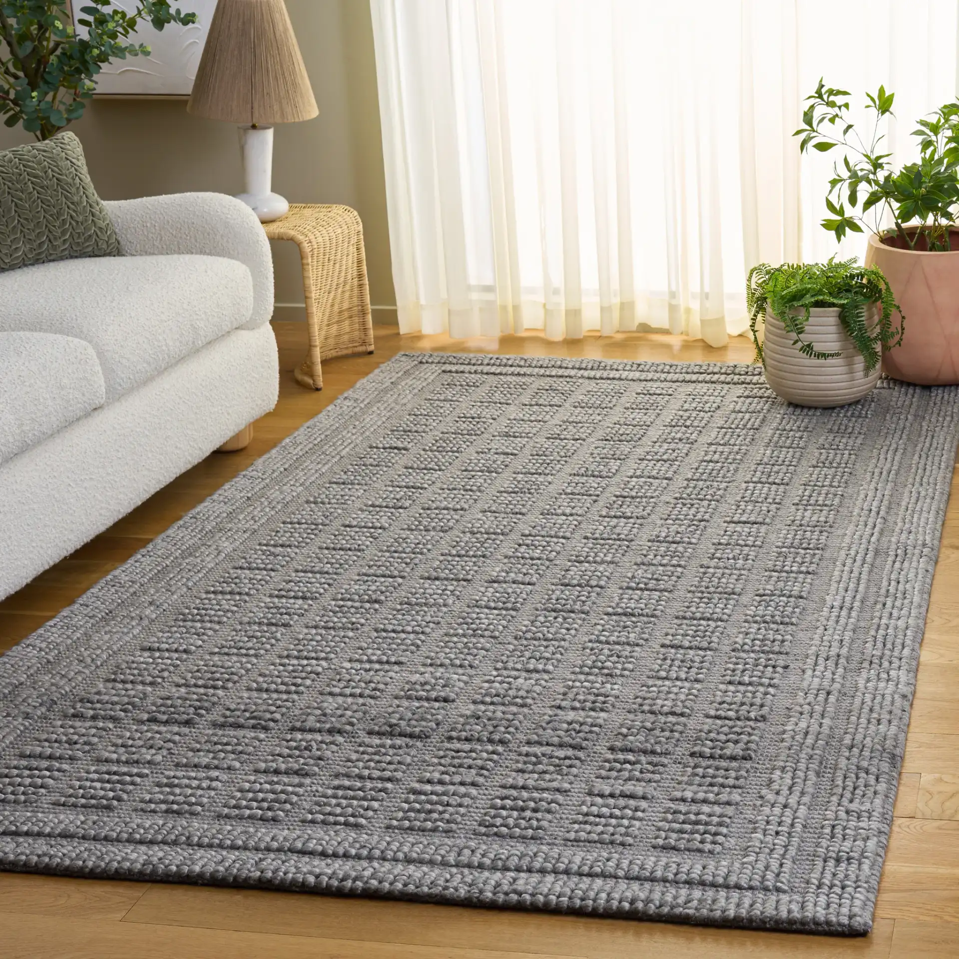 Natura Textured Grid Hand-Woven Rug in Gray in a styled room