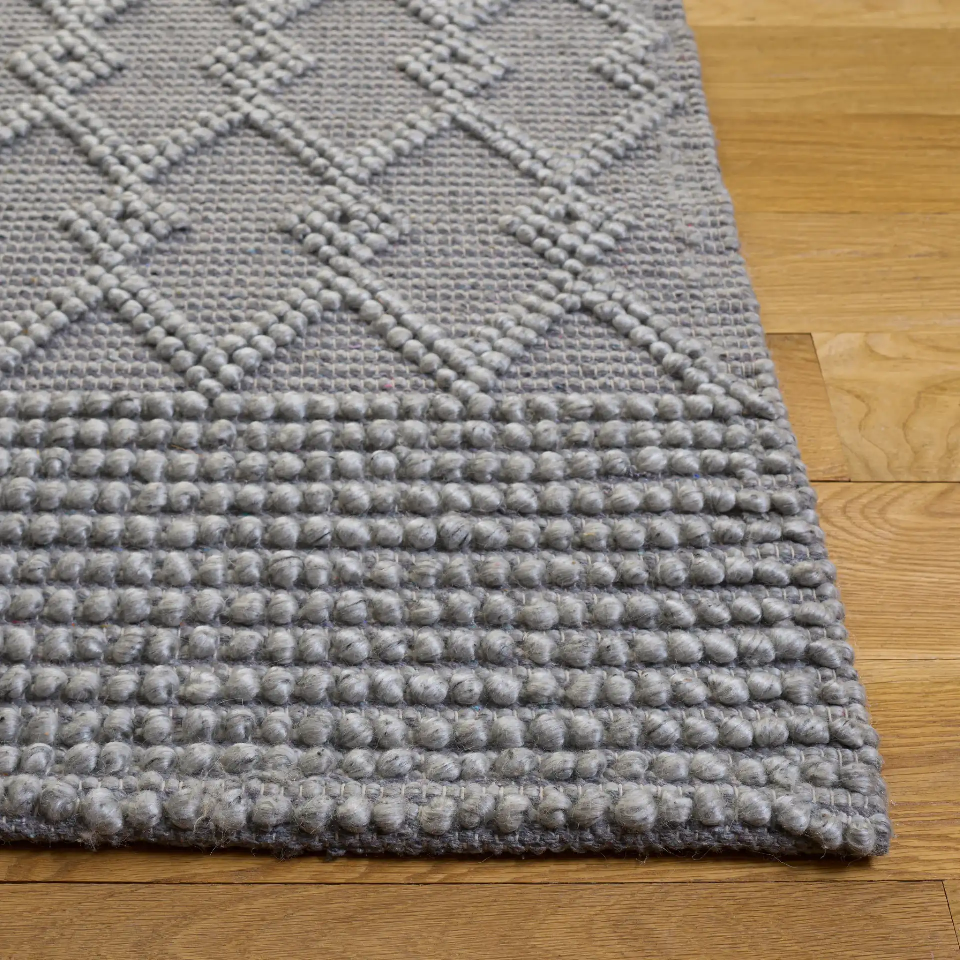 Natura Diamond Lattice Hand-Woven Rug in Gray in a styled room