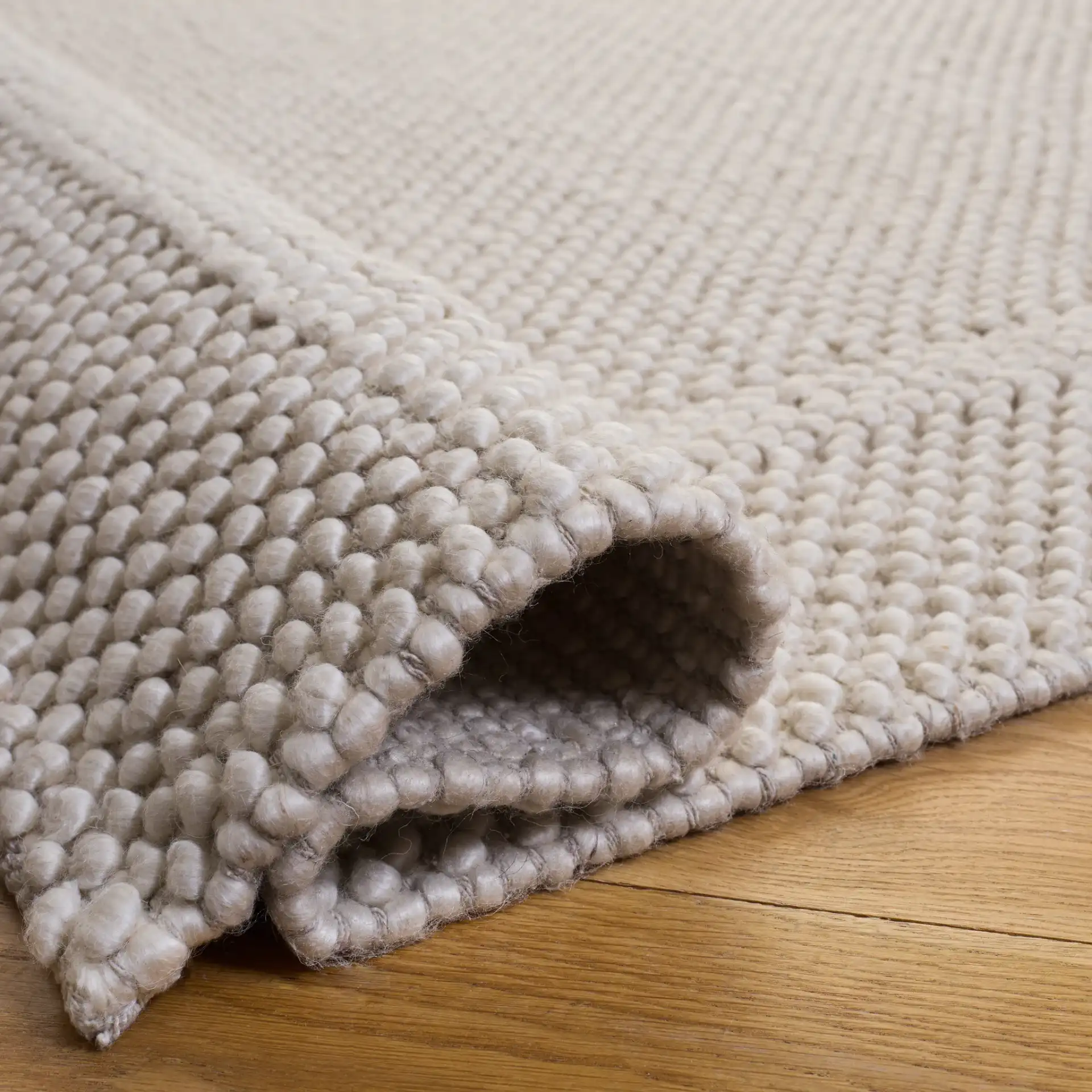 Natura Pebble Border Hand-Woven Rug in Ivory in a styled room
