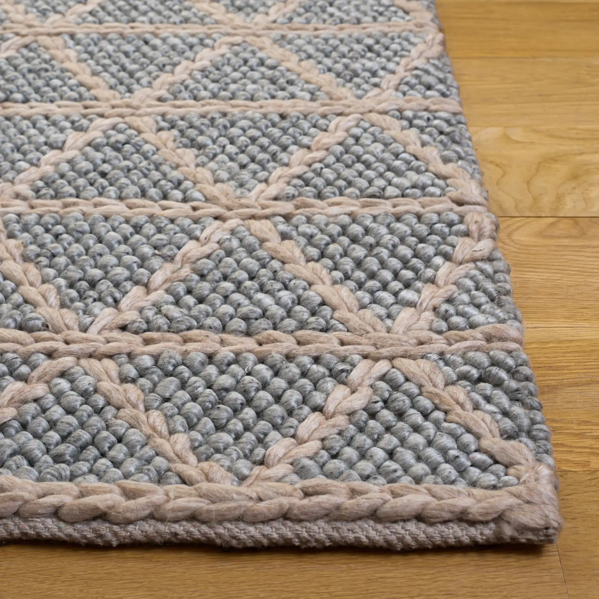 Natura Triangle Grid Hand-Woven Rug in Gray / Beige in a styled room