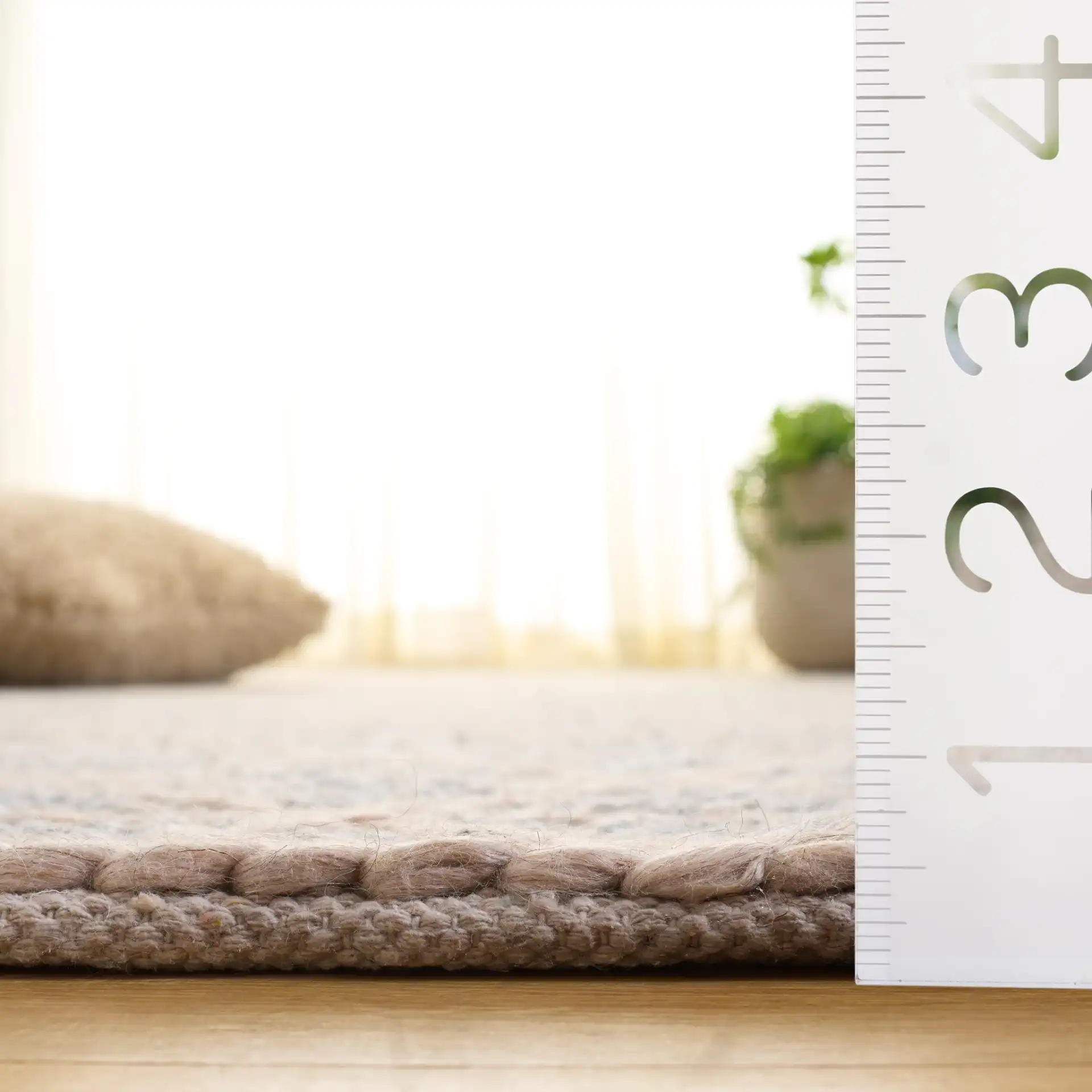 Natura Triangle Grid Hand-Woven Rug in Gray / Beige in a styled room