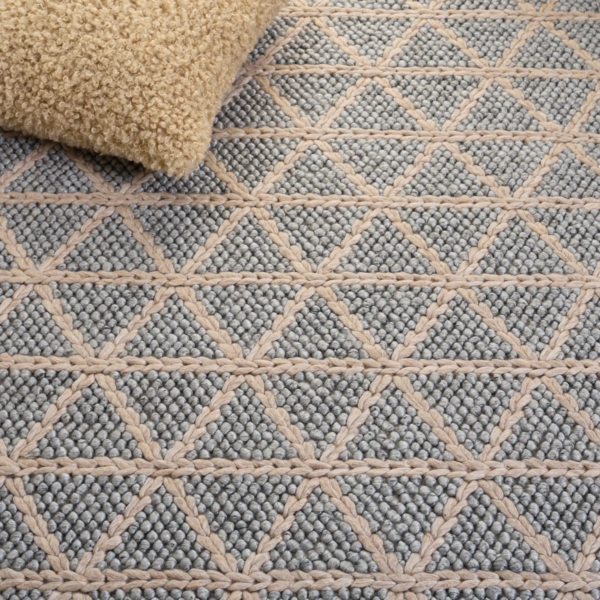 Natura Triangle Grid Hand-Woven Rug in Gray / Beige in a styled room