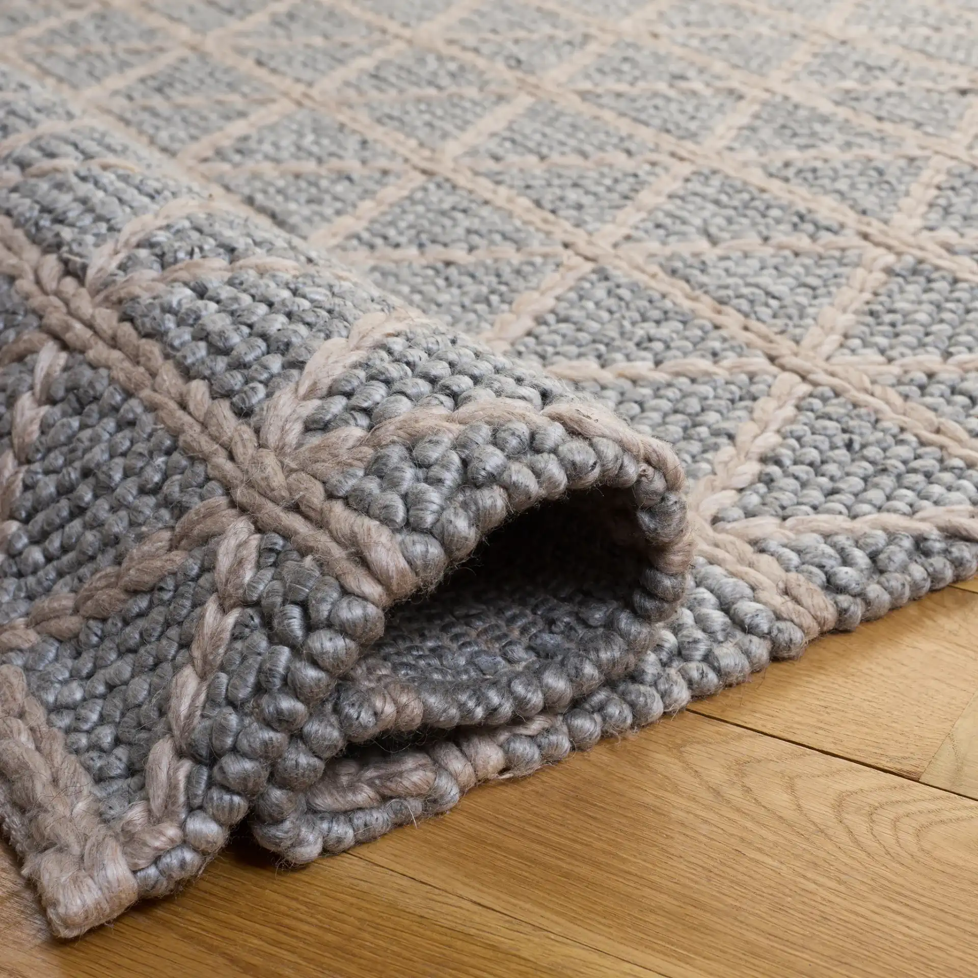 Natura Triangle Grid Hand-Woven Rug in Gray / Beige in a styled room
