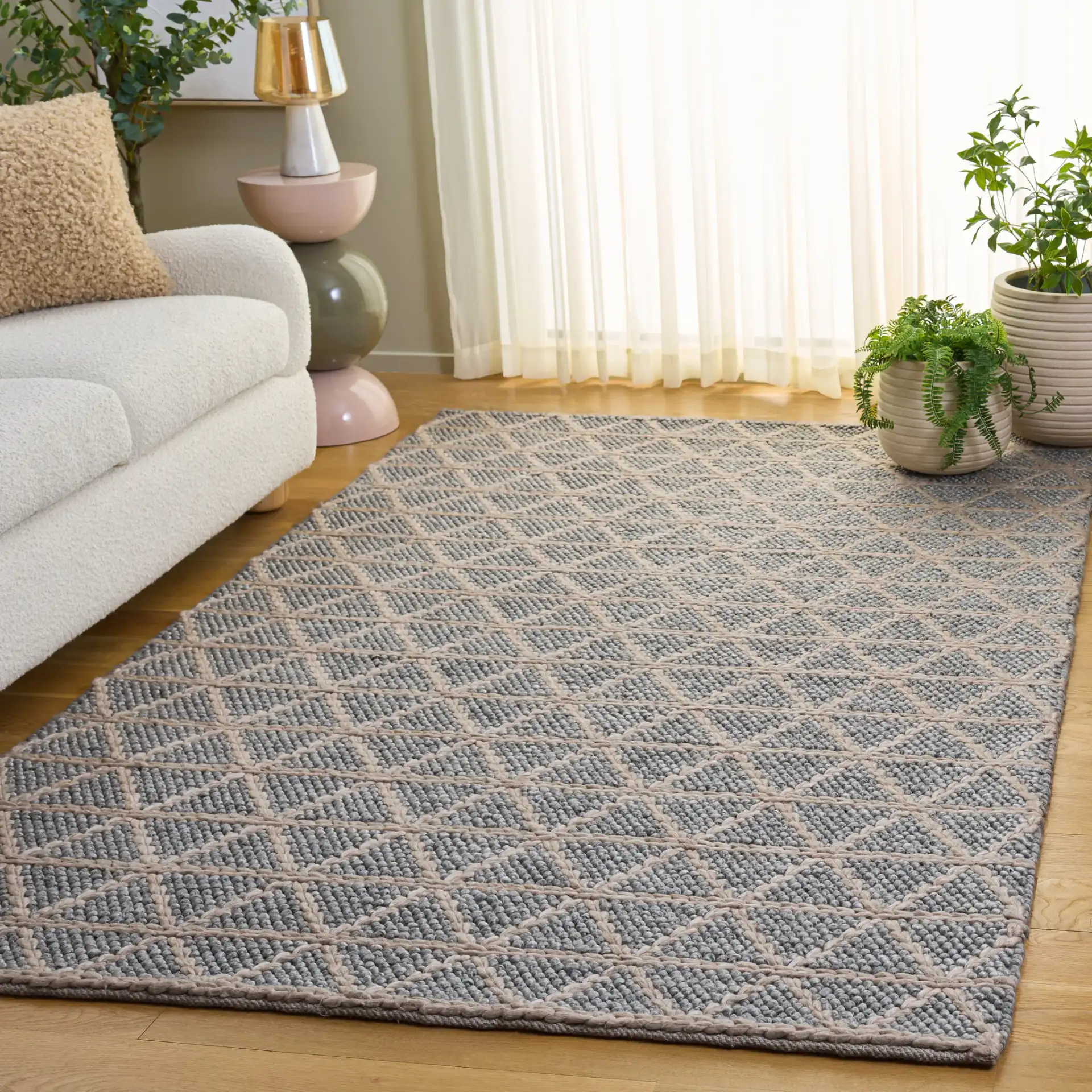 Natura Triangle Grid Hand-Woven Rug in Gray / Beige in a styled room