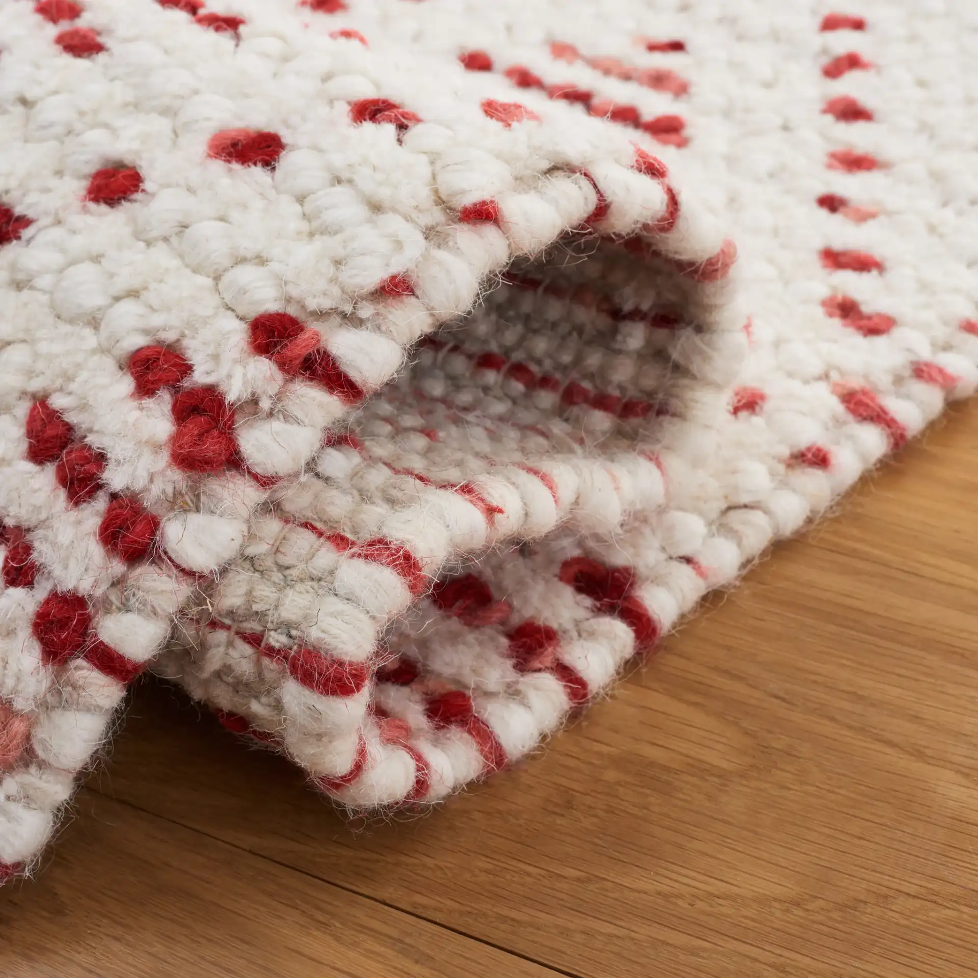 Natura Diamond Hand-Loomed Wool Rug in Ivory / Red in a styled room