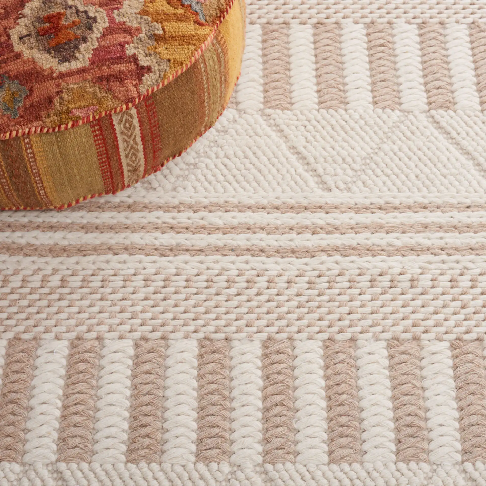 Natura Banded Stripe Hand-Woven Wool Rug in Ivory / Taupe in a styled room