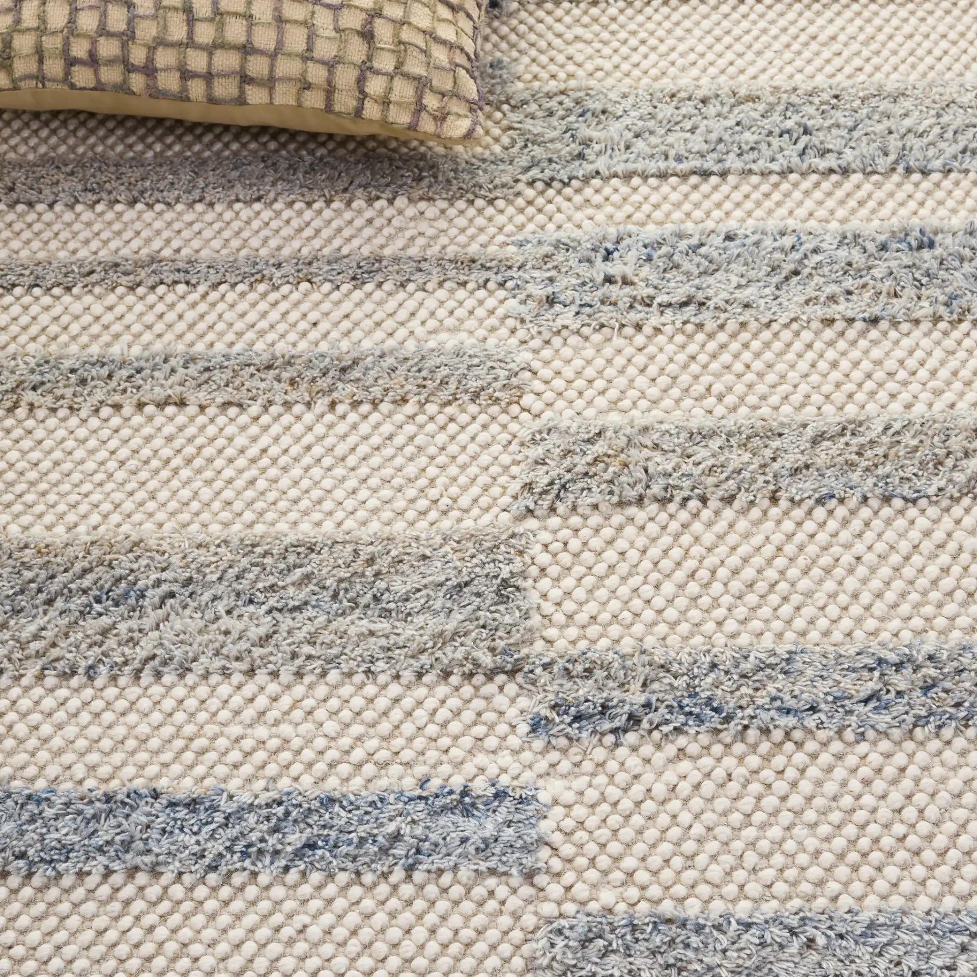 Natura Staggered Stripe Hand-Loomed Wool Blend Rug in Blue / Ivory in a styled room