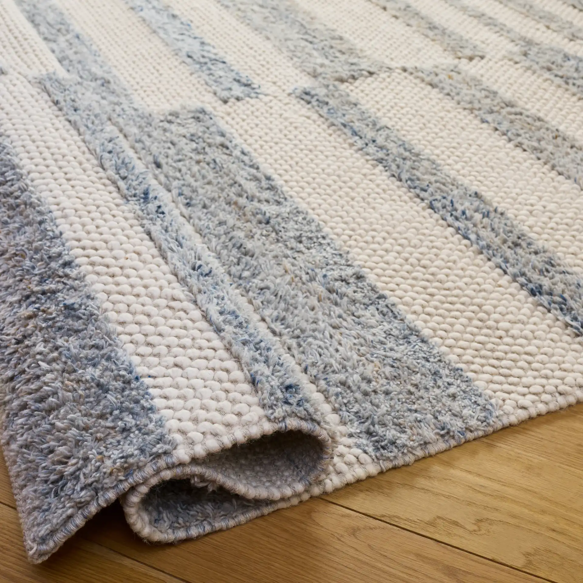 Natura Staggered Stripe Hand-Loomed Wool Blend Rug in Blue / Ivory in a styled room