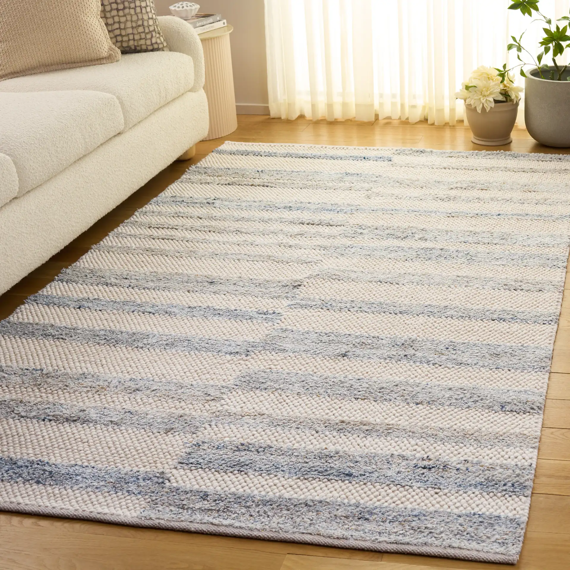 Natura Staggered Stripe Hand-Loomed Wool Blend Rug in Blue / Ivory in a styled room