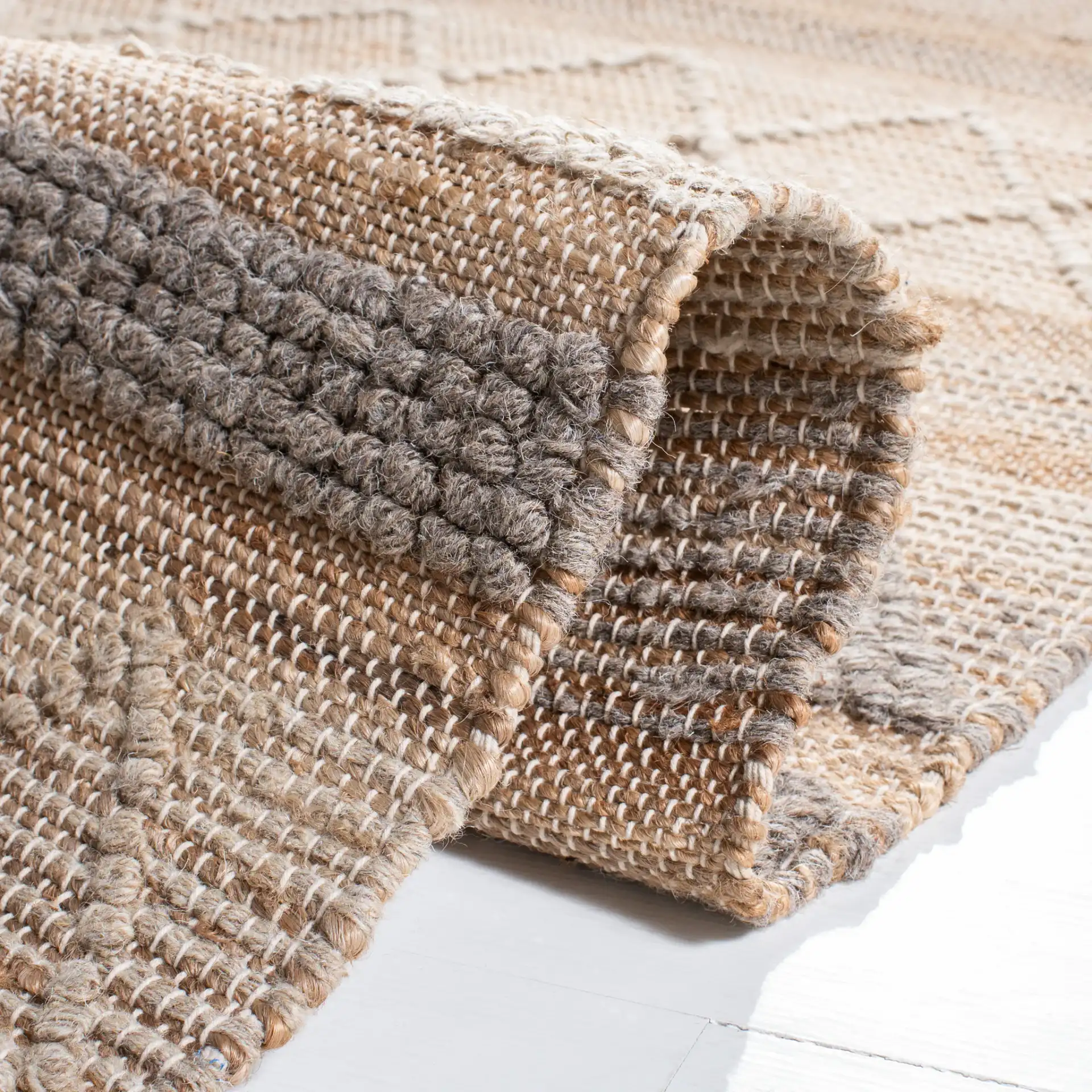 Natura Banded Triangle Flatweave Rug in Natural / Beige in a styled room
