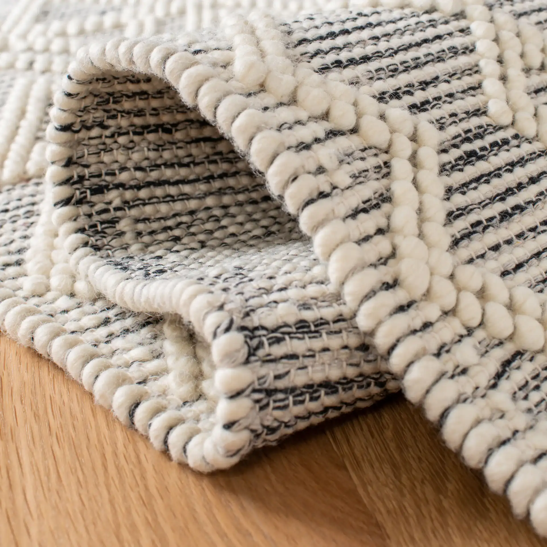 Natura Chevron And Diamond Hand-Loomed Rug in Ivory / Black in a styled room