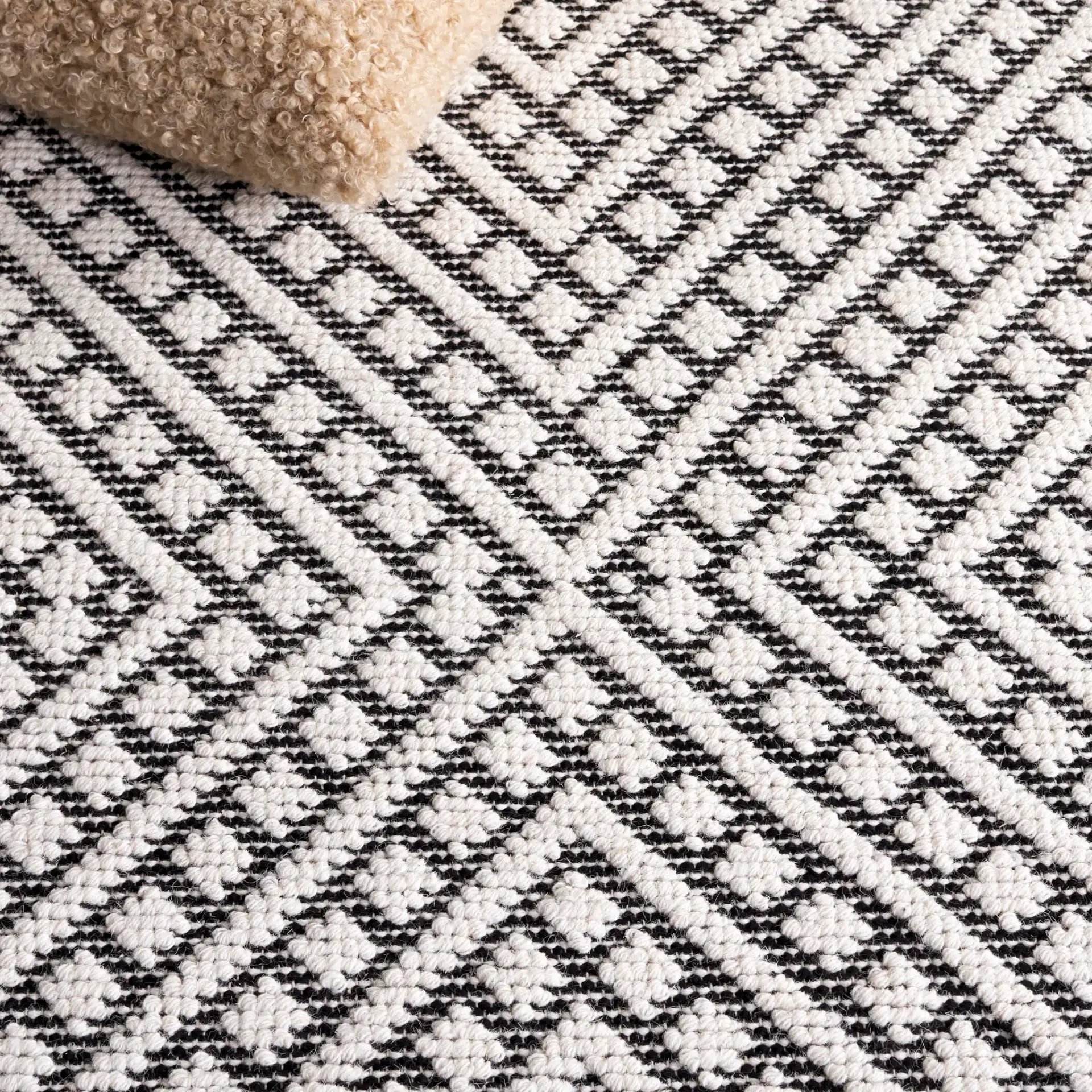 Natura Concentric Chevron Hand-Loomed Wool Rug in Ivory / Black in a styled room