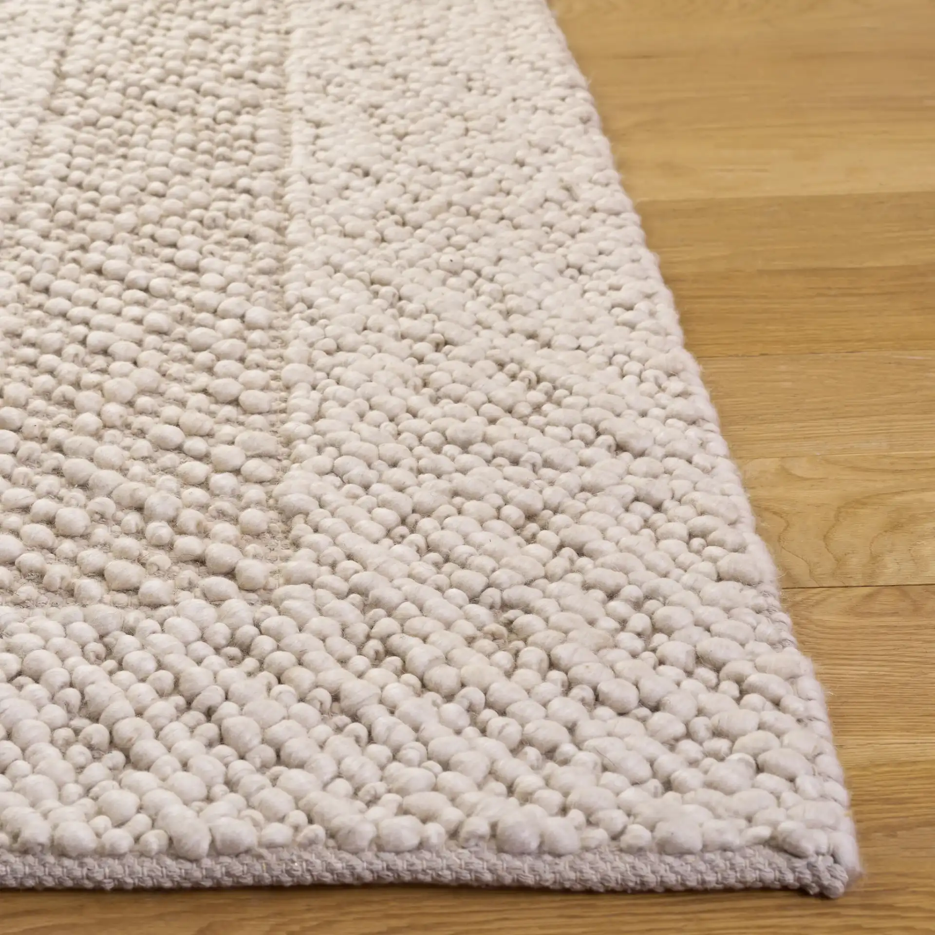 Natura Concentric Border Hand-Woven Rug in Ivory in a styled room