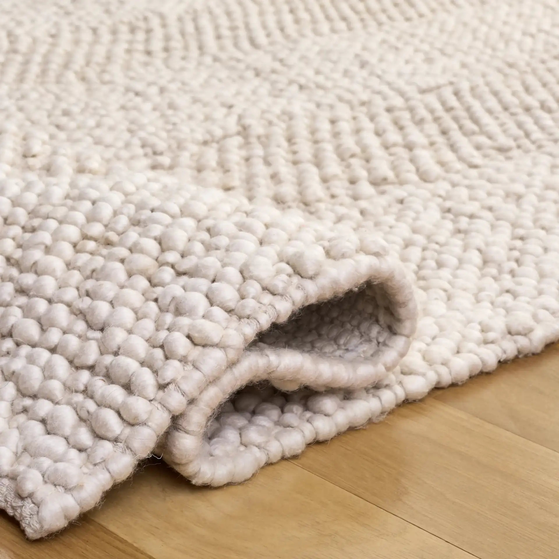 Natura Concentric Border Hand-Woven Rug in Ivory in a styled room