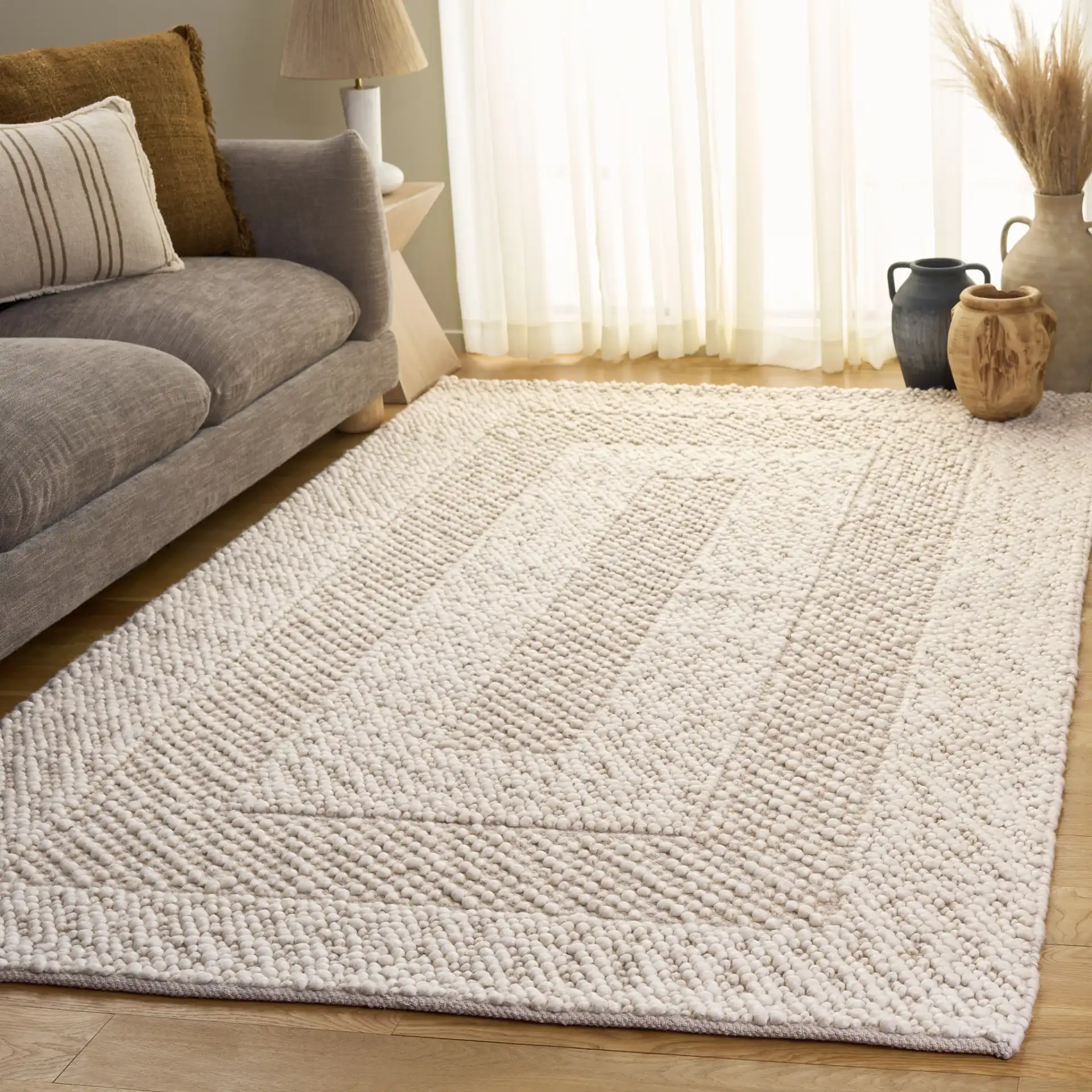 Natura Concentric Border Hand-Woven Rug in Ivory in a styled room