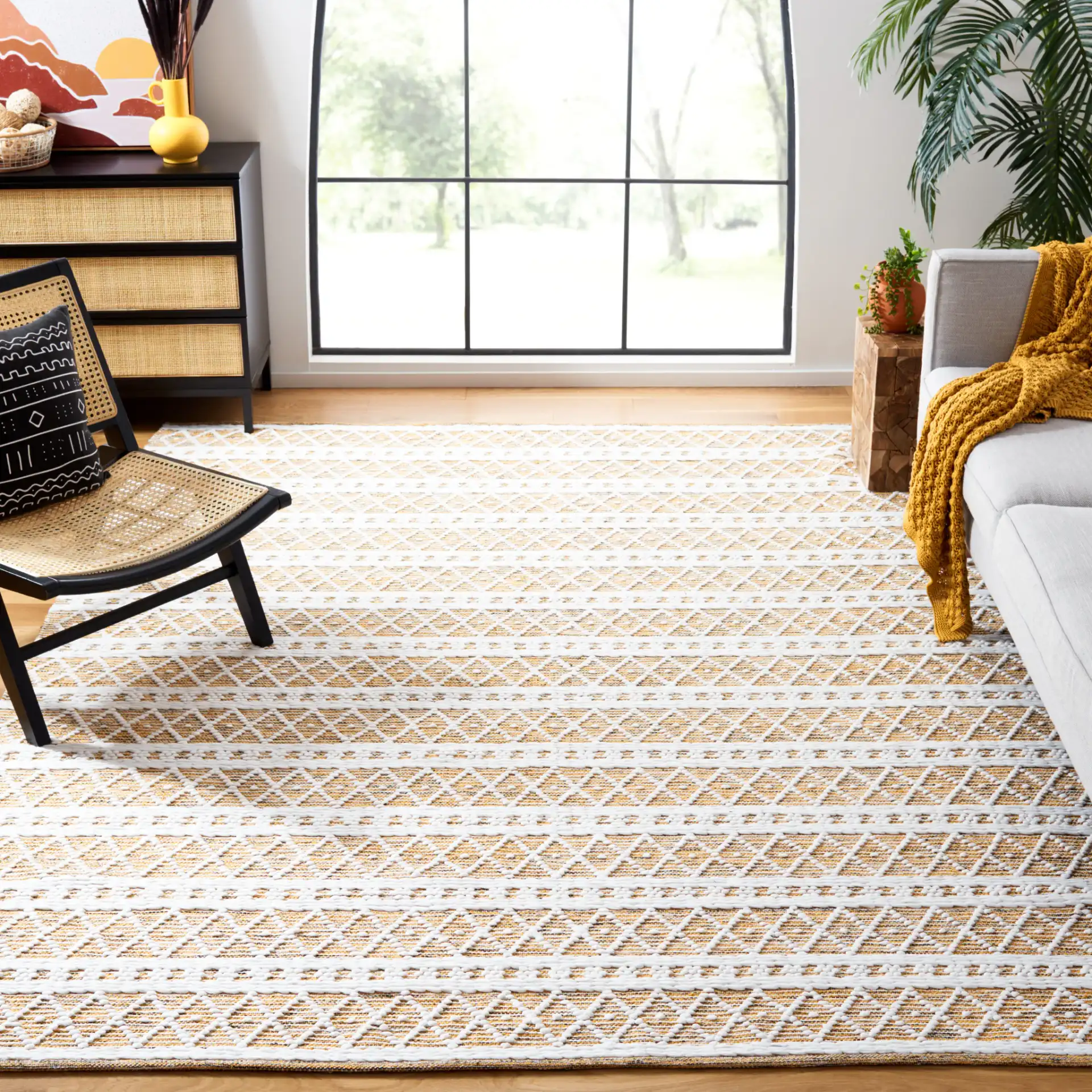 Natura Banded Diamond Lattice Hand-Woven Rug in Gold / Black in a styled room