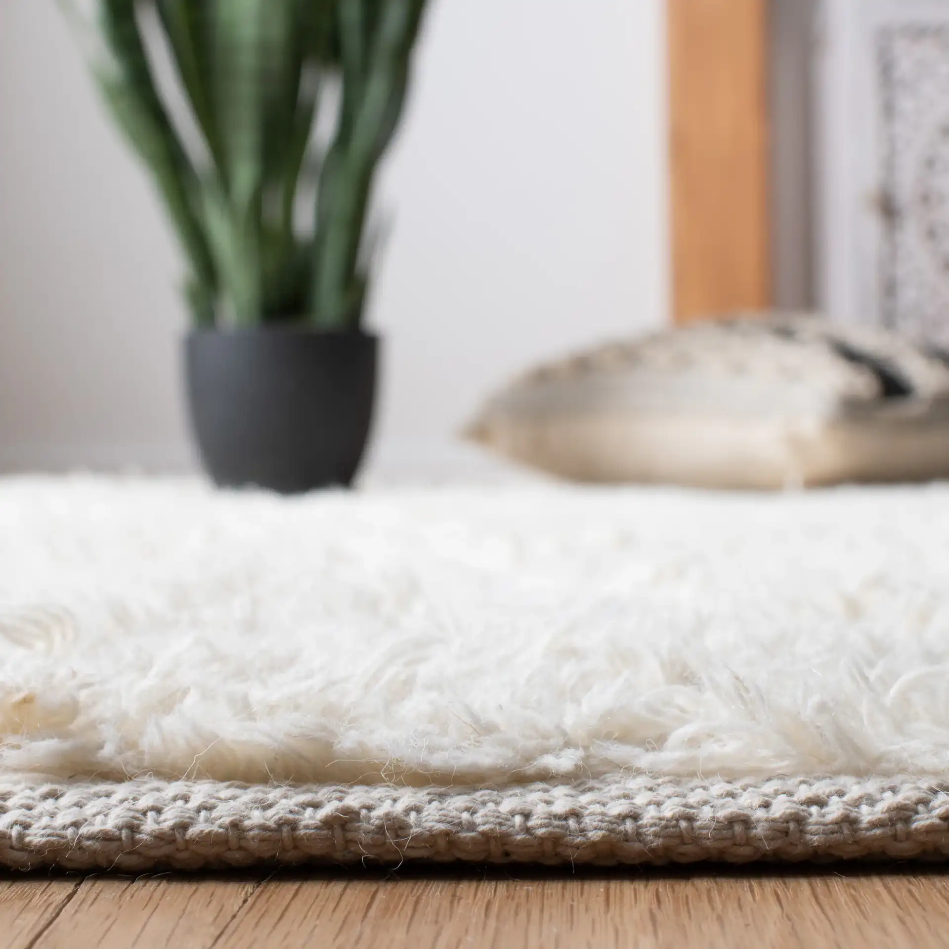 Natura Diamond Trellis Hand-Woven Shag Wool Rug in Ivory / Black in a styled room