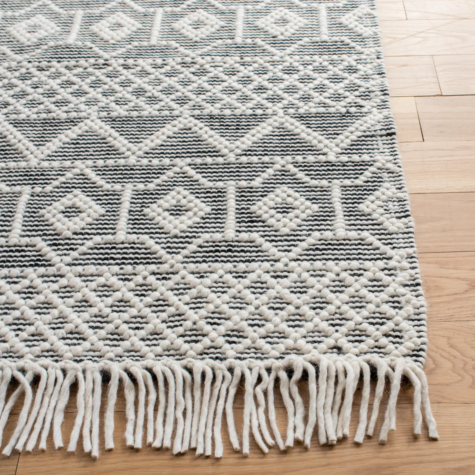 Natura Tribal Chevron Stripe Hand-Loomed Wool Rug in Ivory / Black in a styled room