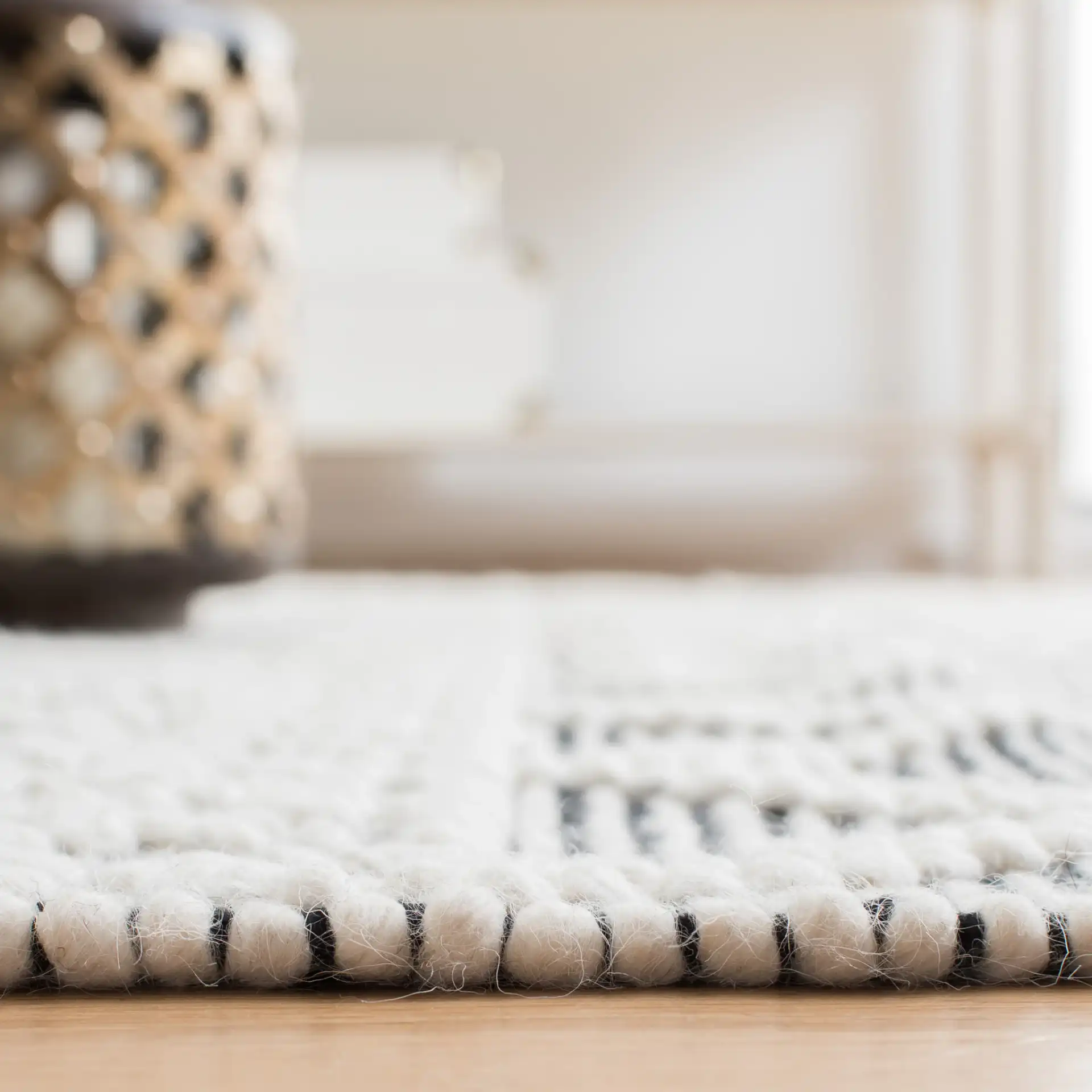 Natura Tribal Chevron Stripe Hand-Loomed Wool Rug in Ivory / Black in a styled room