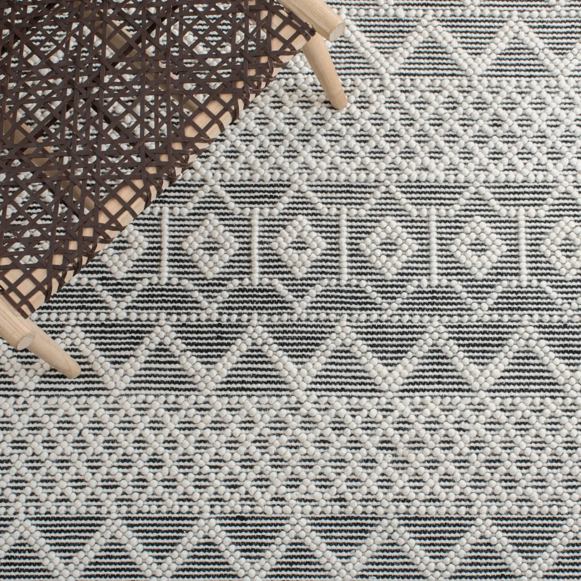 Natura Tribal Chevron Stripe Hand-Loomed Wool Rug in Ivory / Black in a styled room