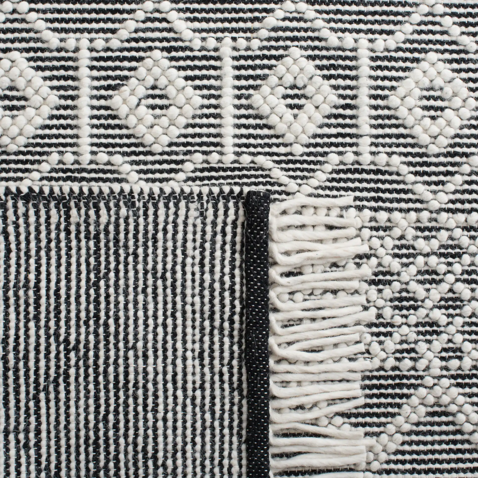 Natura Tribal Chevron Stripe Hand-Loomed Wool Rug in Ivory / Black in a styled room