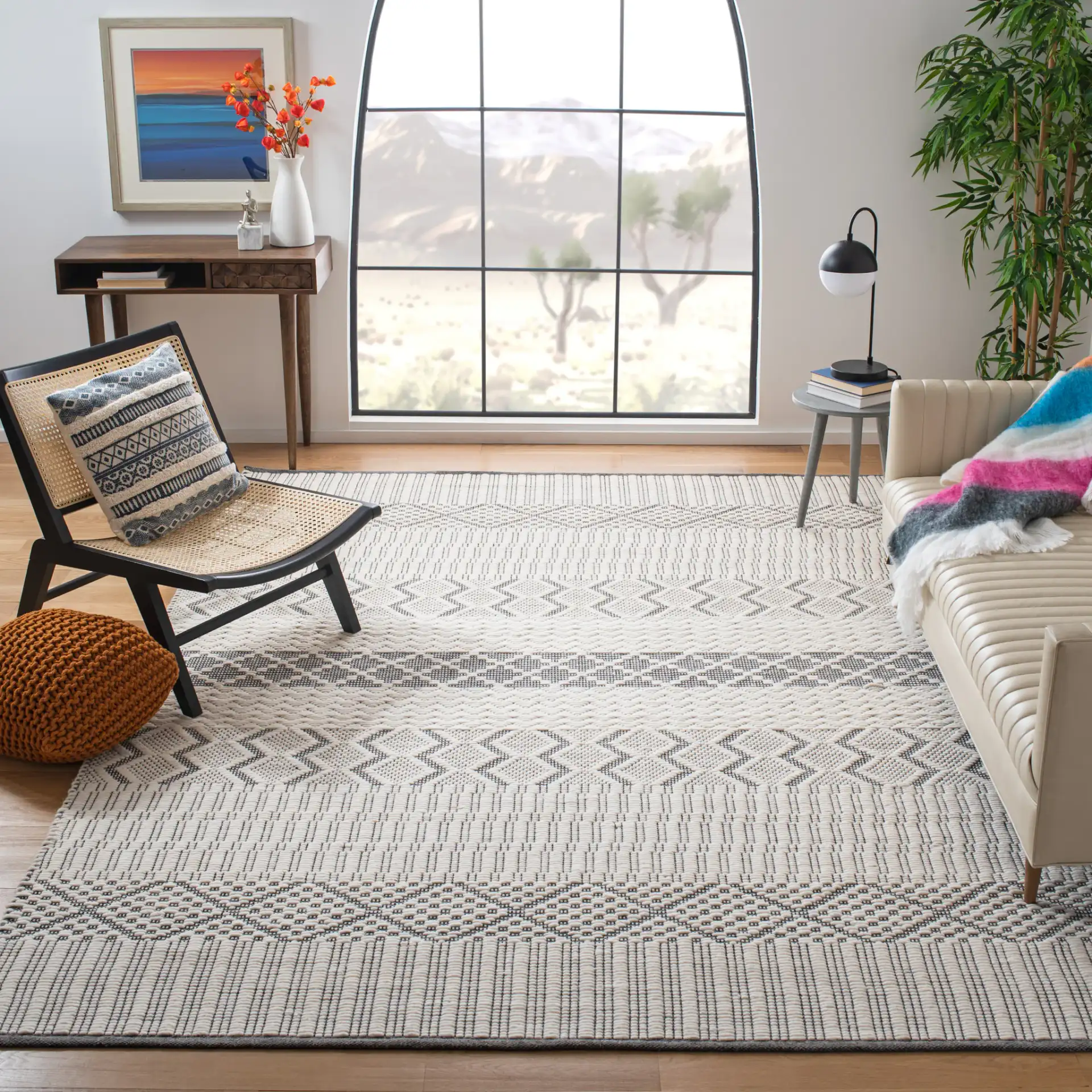 Natura Banded Tribal Geometric Hand-Woven Wool Rug in Ivory / Gray in a styled room