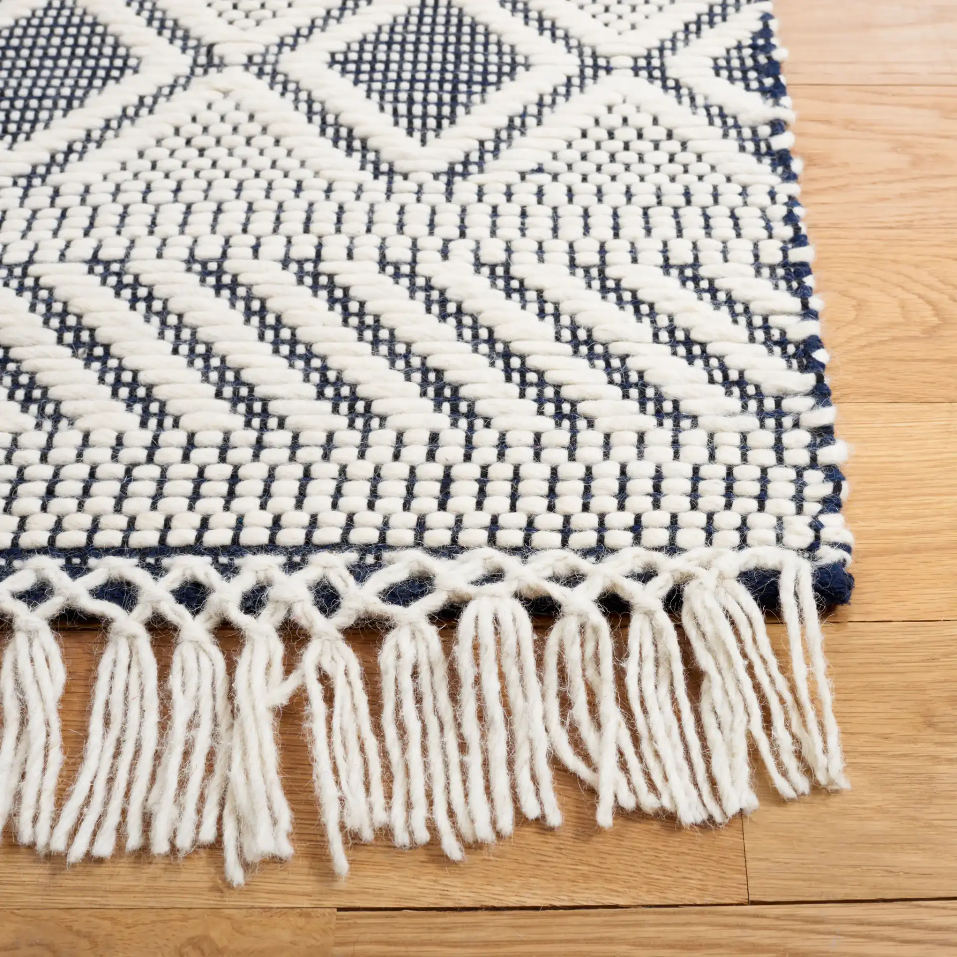 Natura Banded Lozenge Geometric Hand-Woven Wool Rug in Ivory / Navy in a styled room