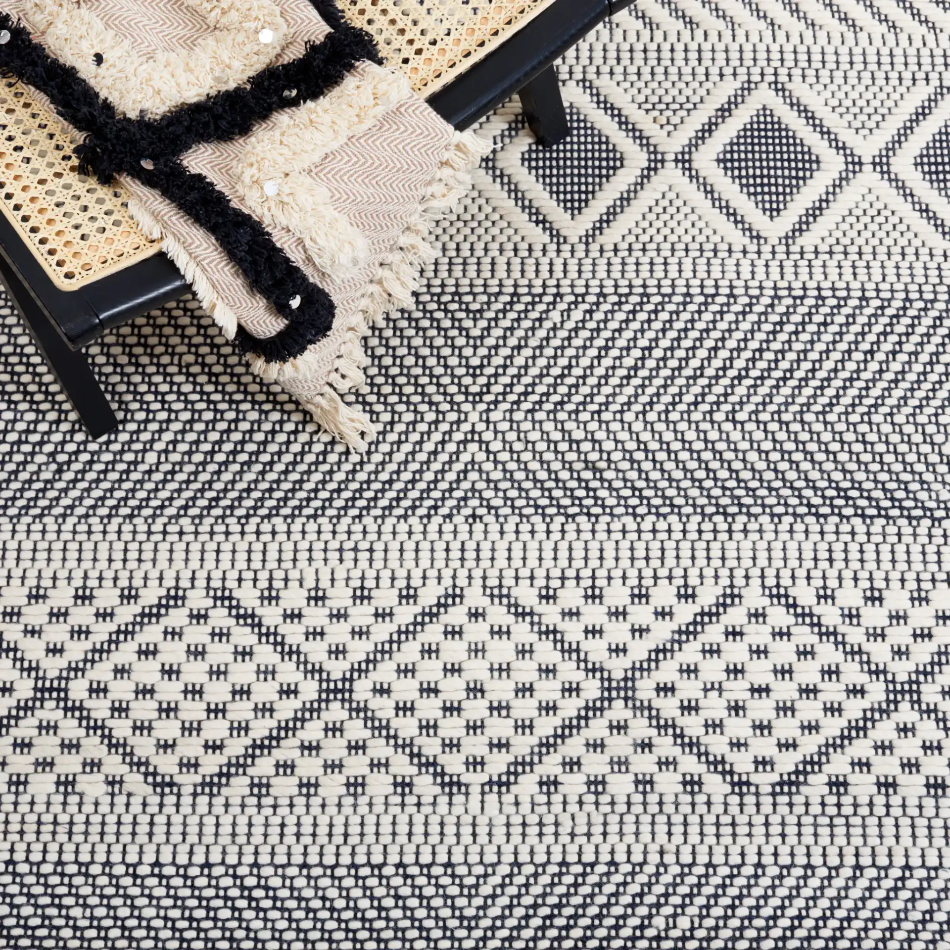 Natura Banded Lozenge Geometric Hand-Woven Wool Rug in Ivory / Navy in a styled room
