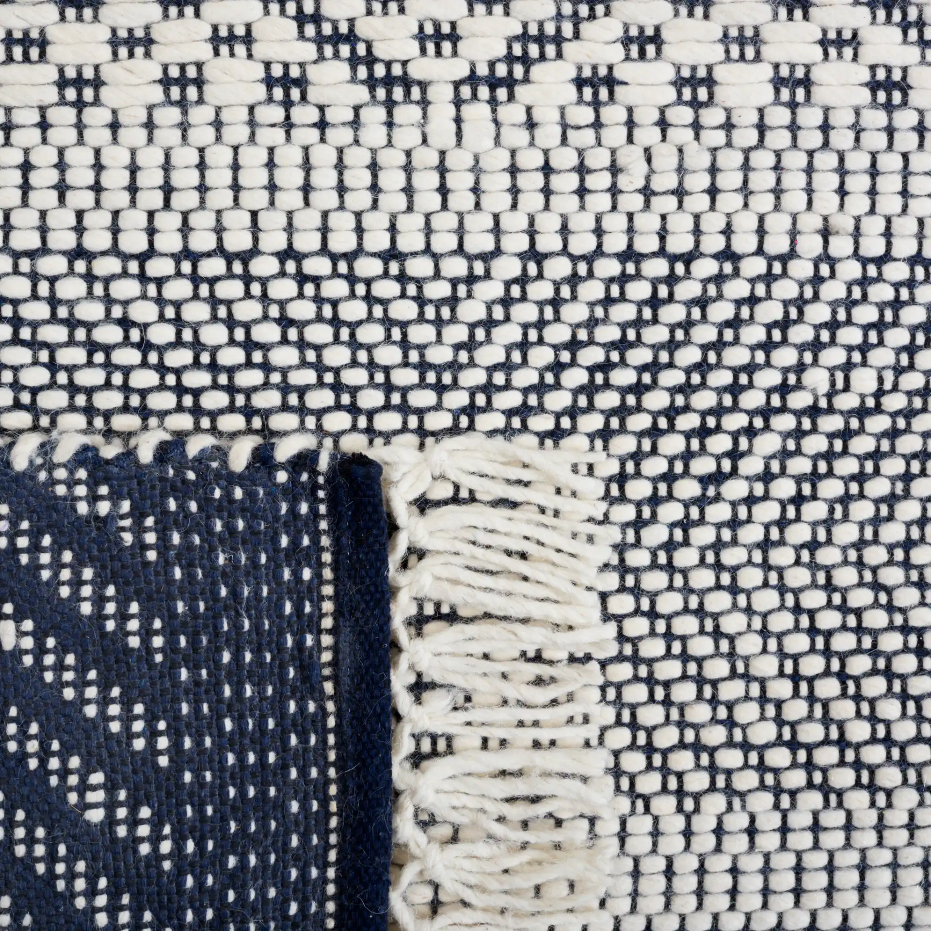 Natura Banded Lozenge Geometric Hand-Woven Wool Rug in Ivory / Navy in a styled room