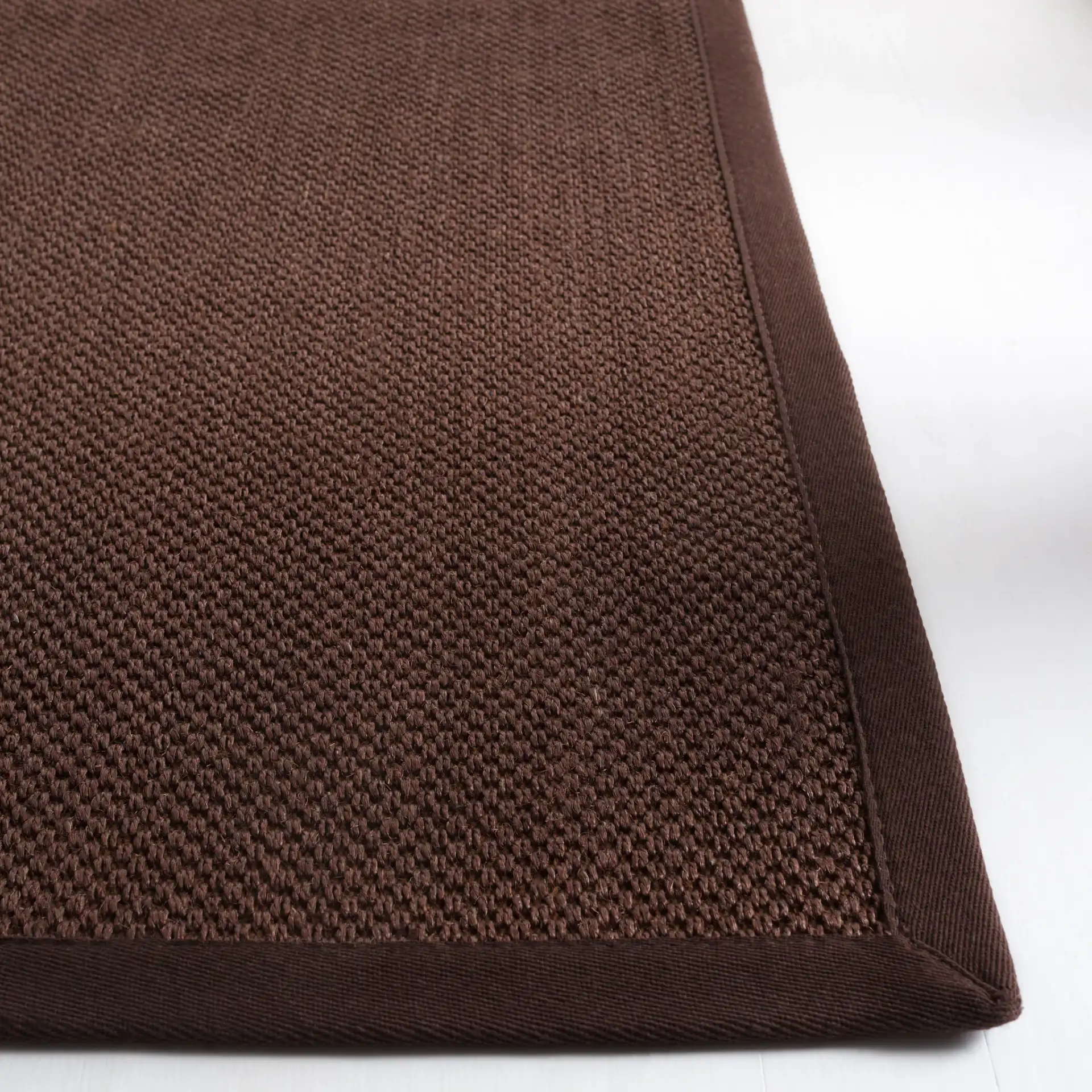 Natural Fiber Bordered Boucle Grid Sisal Rug in Chocolate / Dark Brown in a styled room
