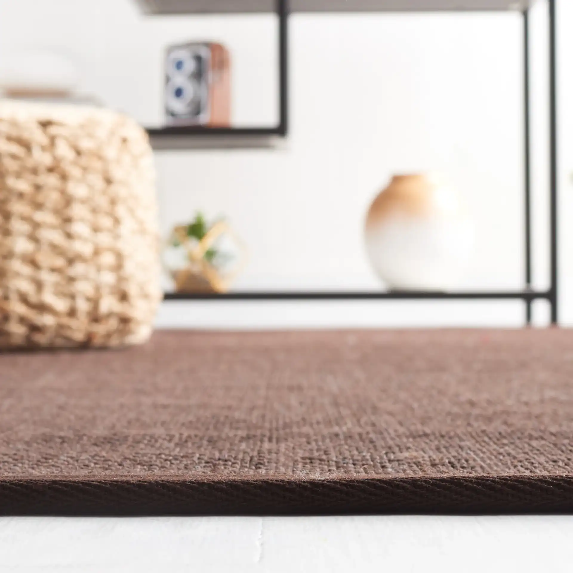 Natural Fiber Bordered Boucle Grid Sisal Rug in Chocolate / Dark Brown in a styled room