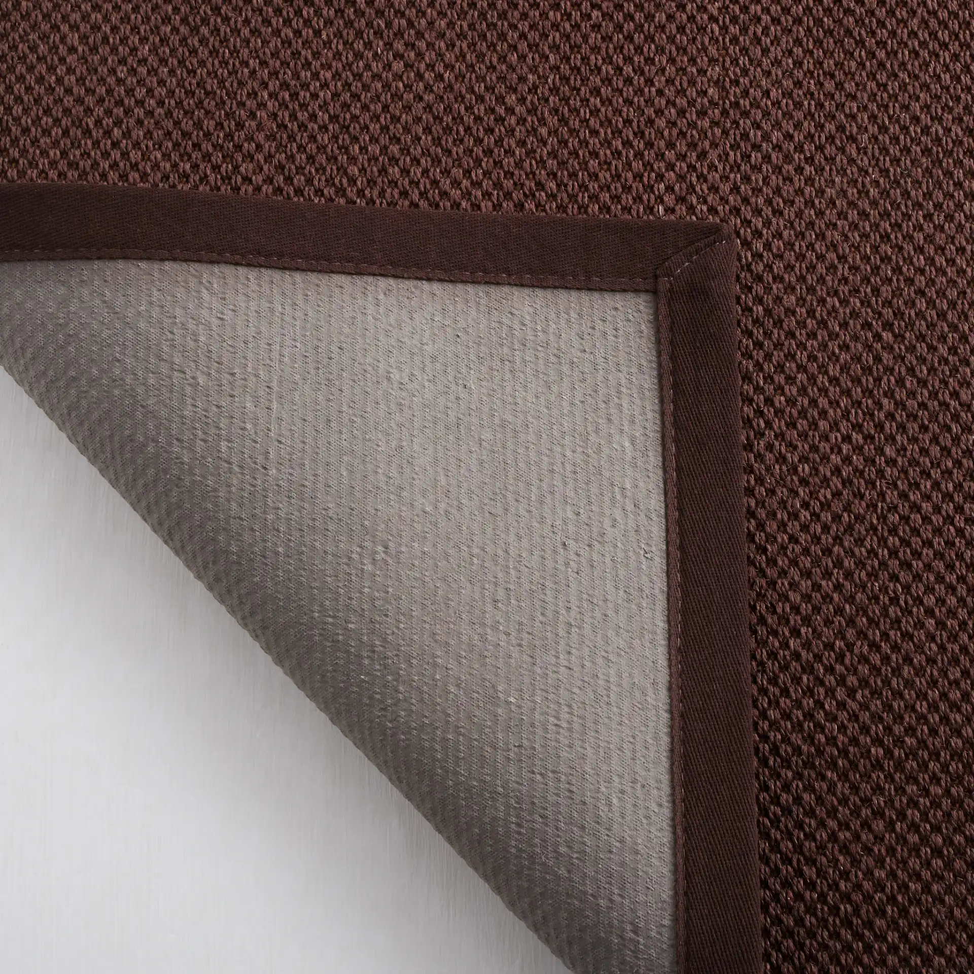 Natural Fiber Bordered Boucle Grid Sisal Rug in Chocolate / Dark Brown in a styled room