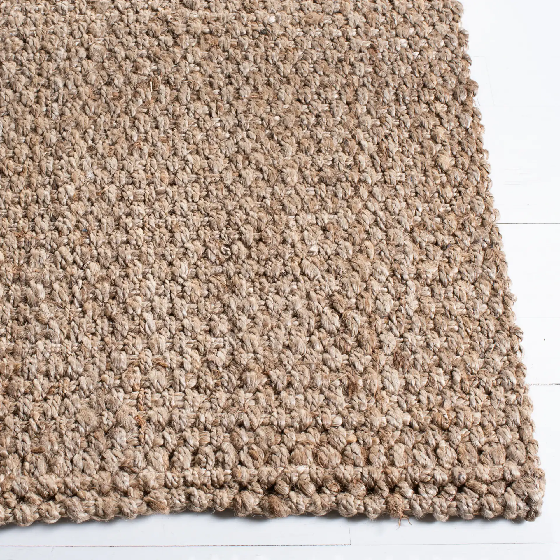 Natural Fiber Pebble Loop Hand-Loomed Jute Rug in Natural in a styled room