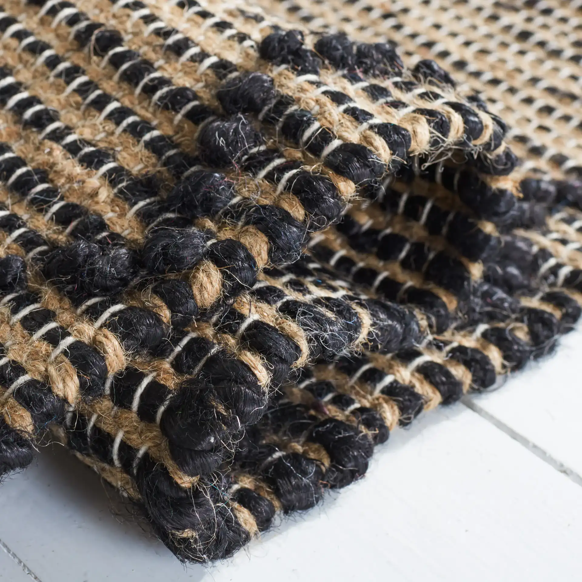 Natural Fiber Diamond Grid Flatweave Jute Rug in Black / Natural in a styled room