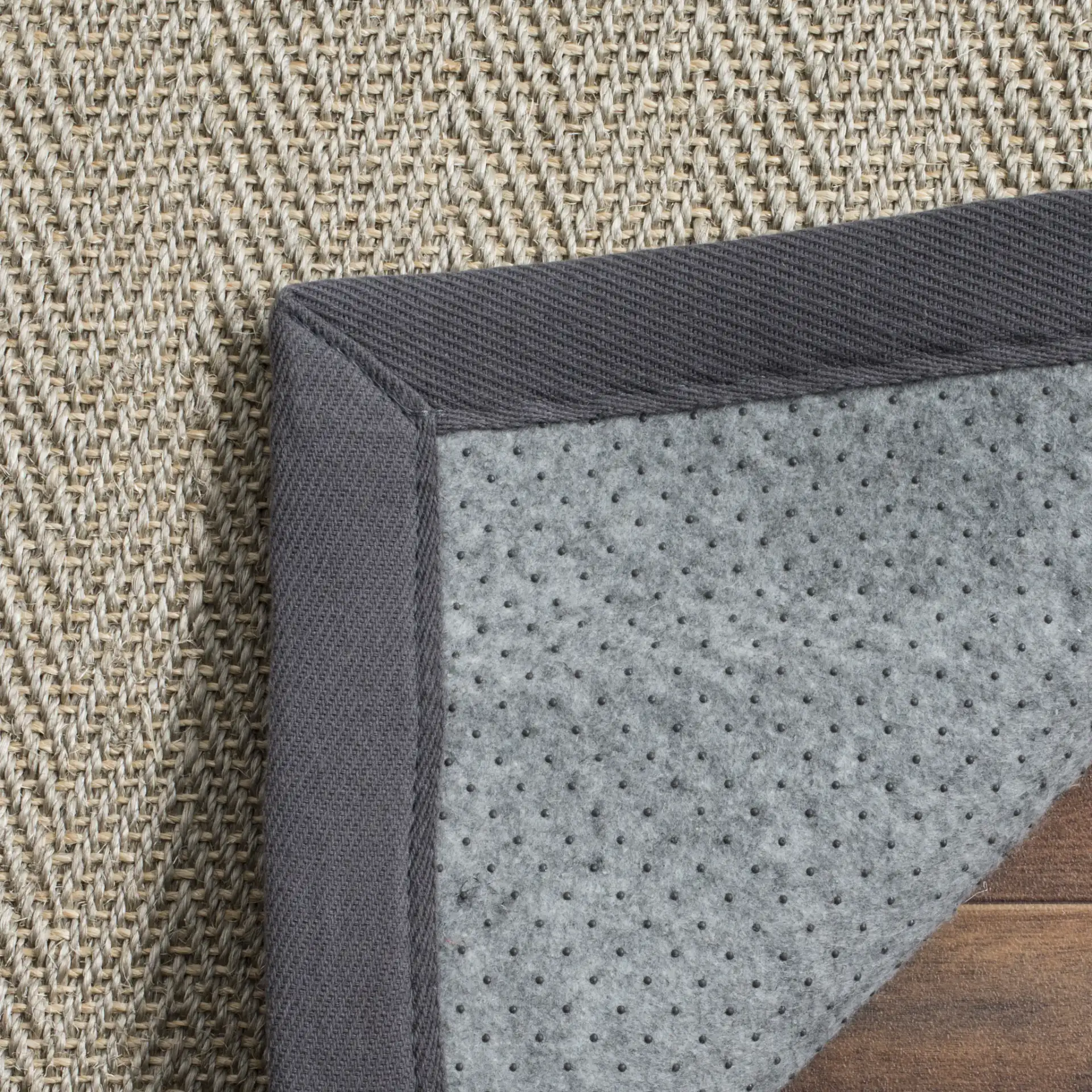 Natural Fiber Solid Bordered Rug in Gray Brown / Gray in a styled room