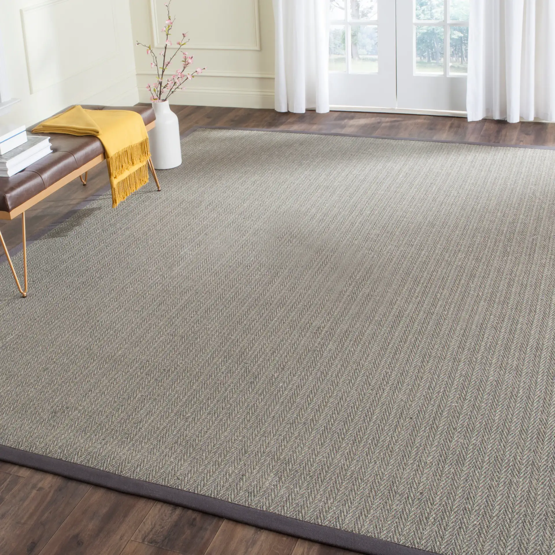 Natural Fiber Solid Bordered Rug in Gray Brown / Gray in a styled room