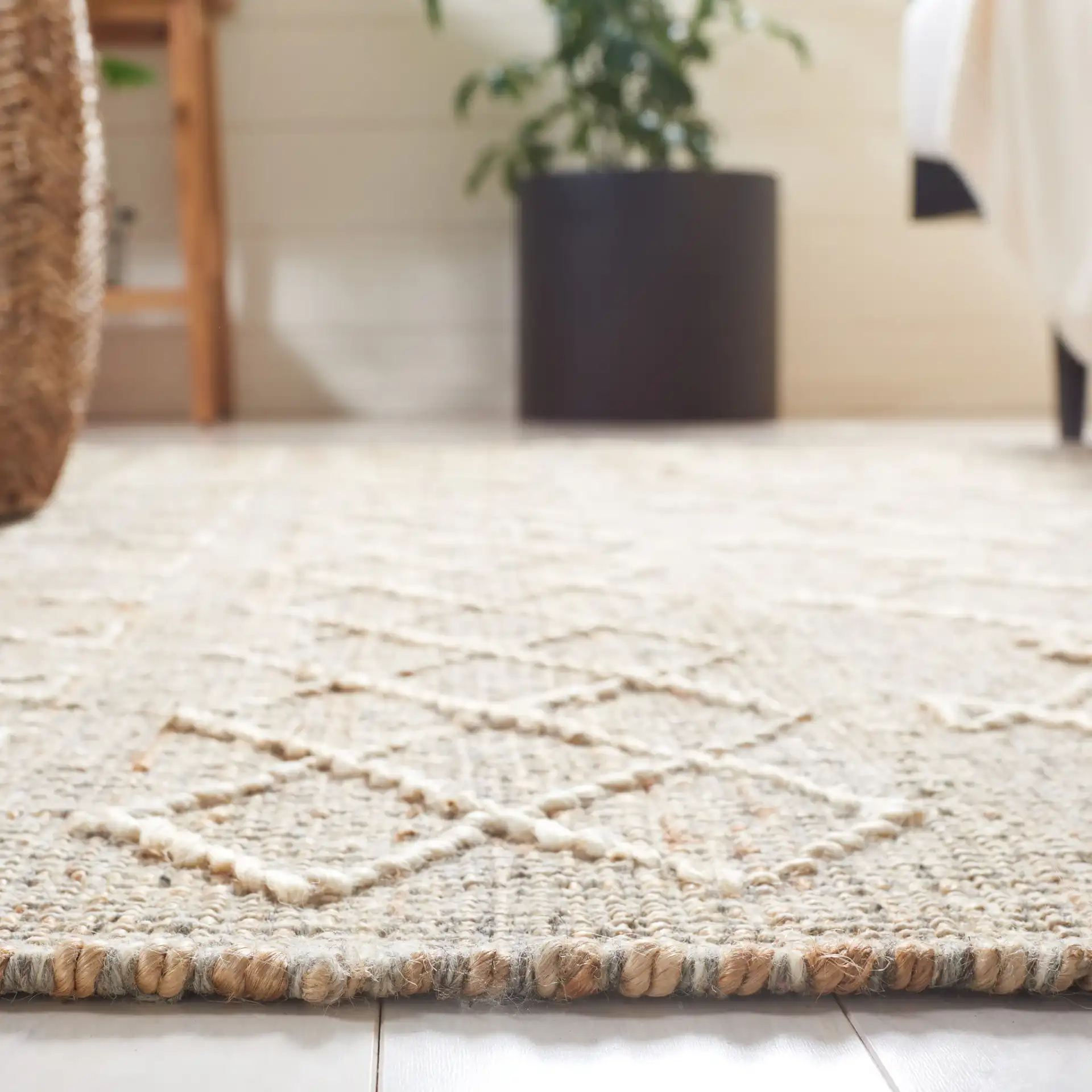 Natural Fiber Banded Geometric Hand-Loomed Jute Rug in Natural / Ivory in a styled room