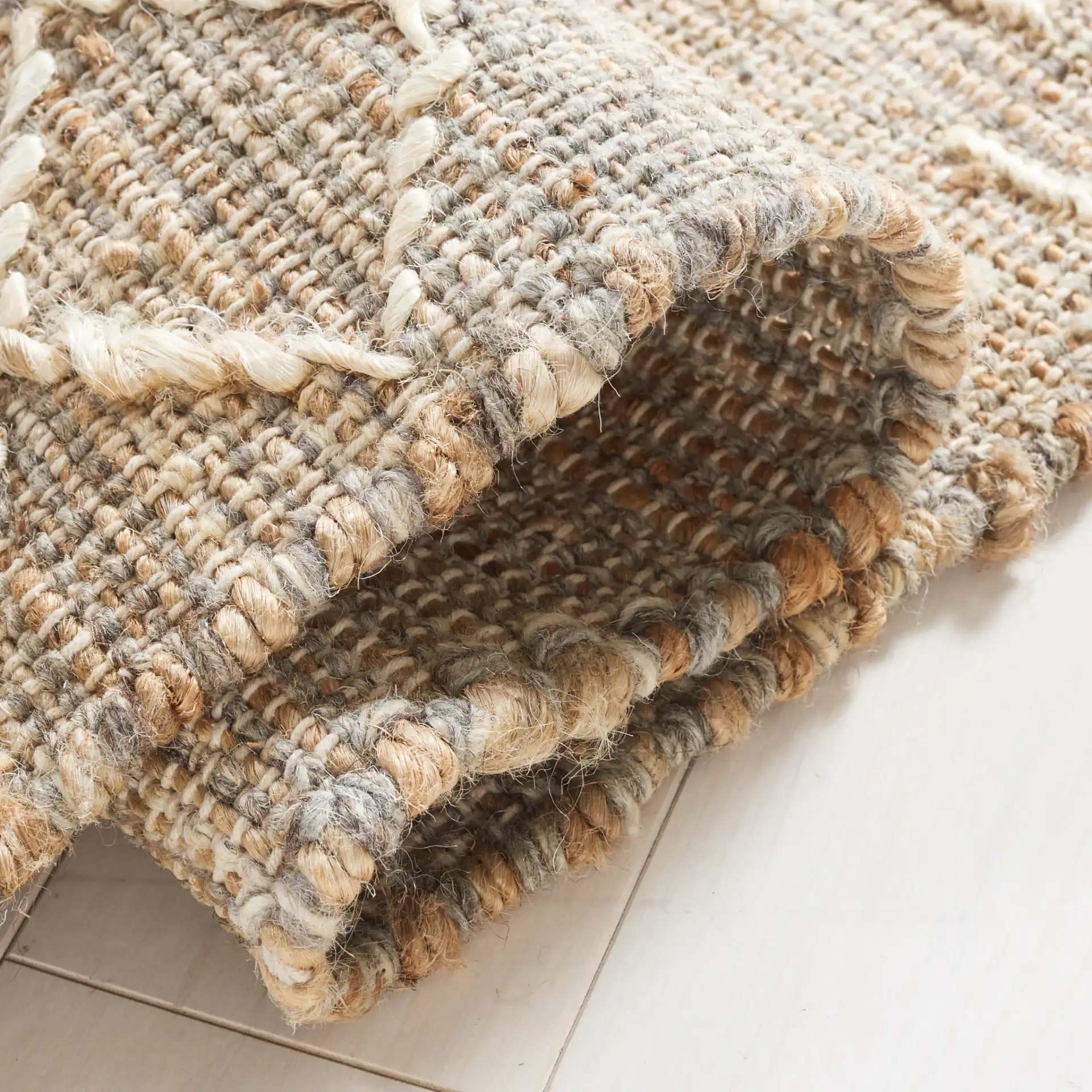 Natural Fiber Banded Geometric Hand-Loomed Jute Rug in Natural / Ivory in a styled room