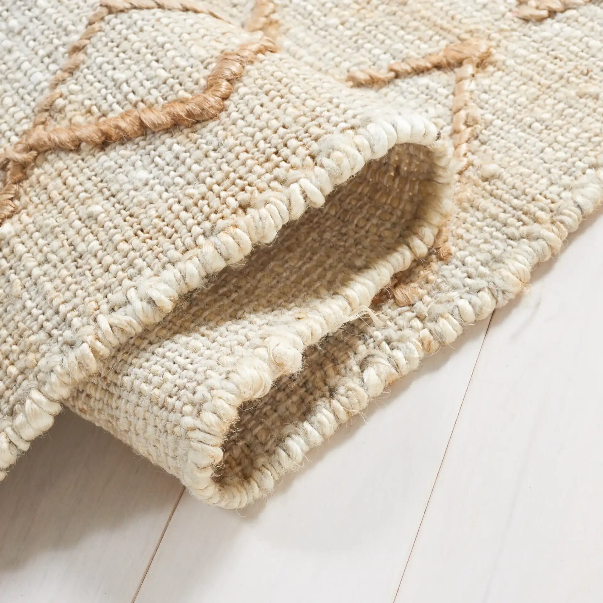 Natural Fiber Geometric Banded Hand-Loomed Jute Rug in Natural / Beige in a styled room